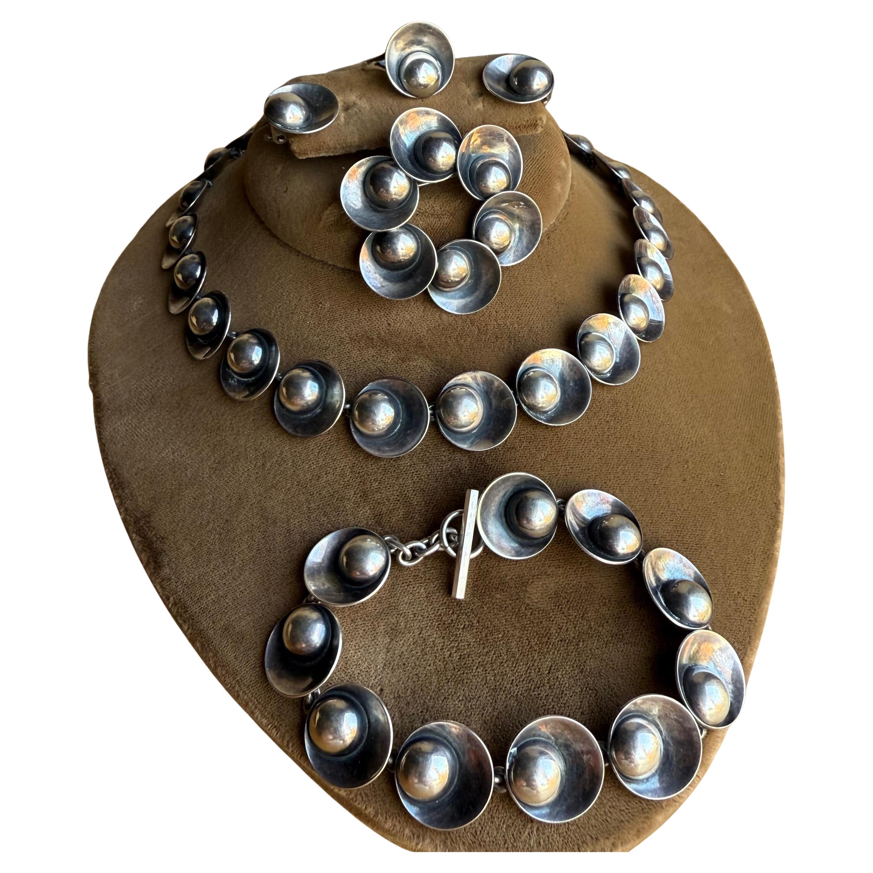 Niels Erik From, Denmark Modernist Sterling Parure Set, Including Necklace, Bracelet, Brooch, Earrings and a Ring.
Original Matching Set From an Estate
Each Piece is signed individually
Measurements:
Necklace 15”, 35 grams
Bracelet 8&34”, 15