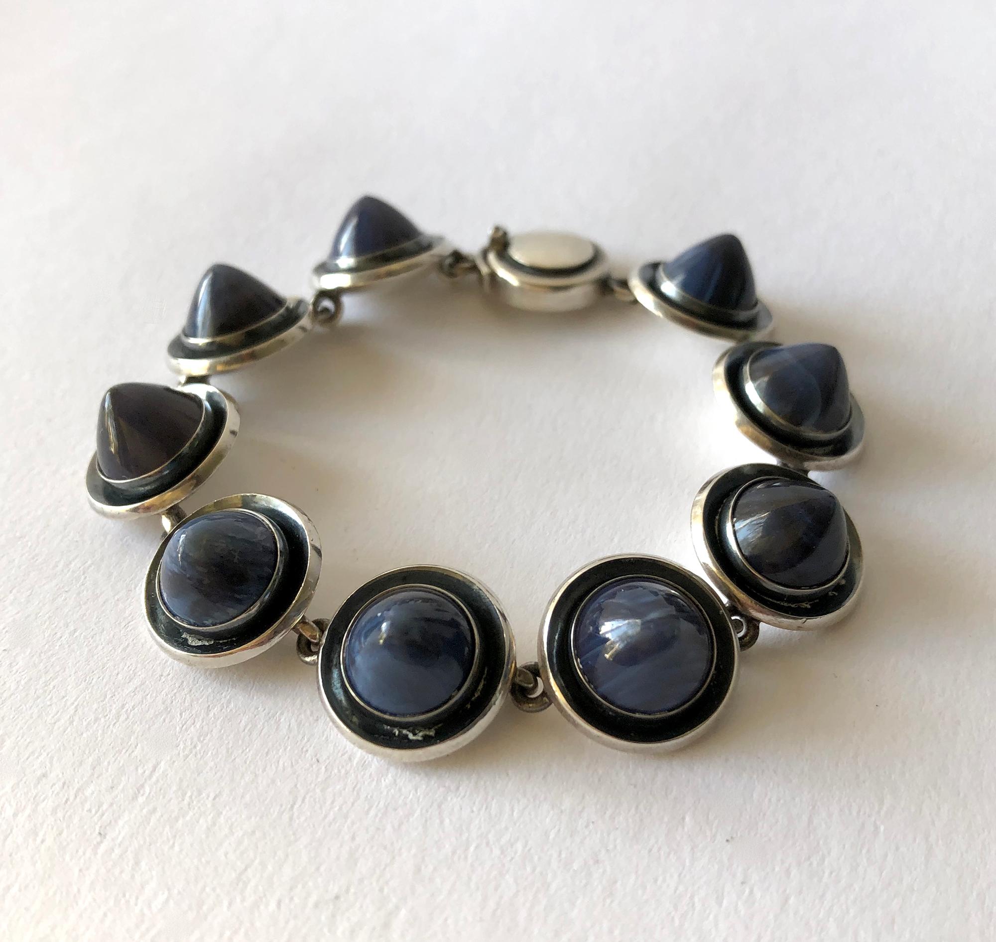 Danish modern sterling silver linked bracelet with conical shaped striped blue agate stones created by Niels Erik From, circa 1960's.  Bracelet measures 7 1/4