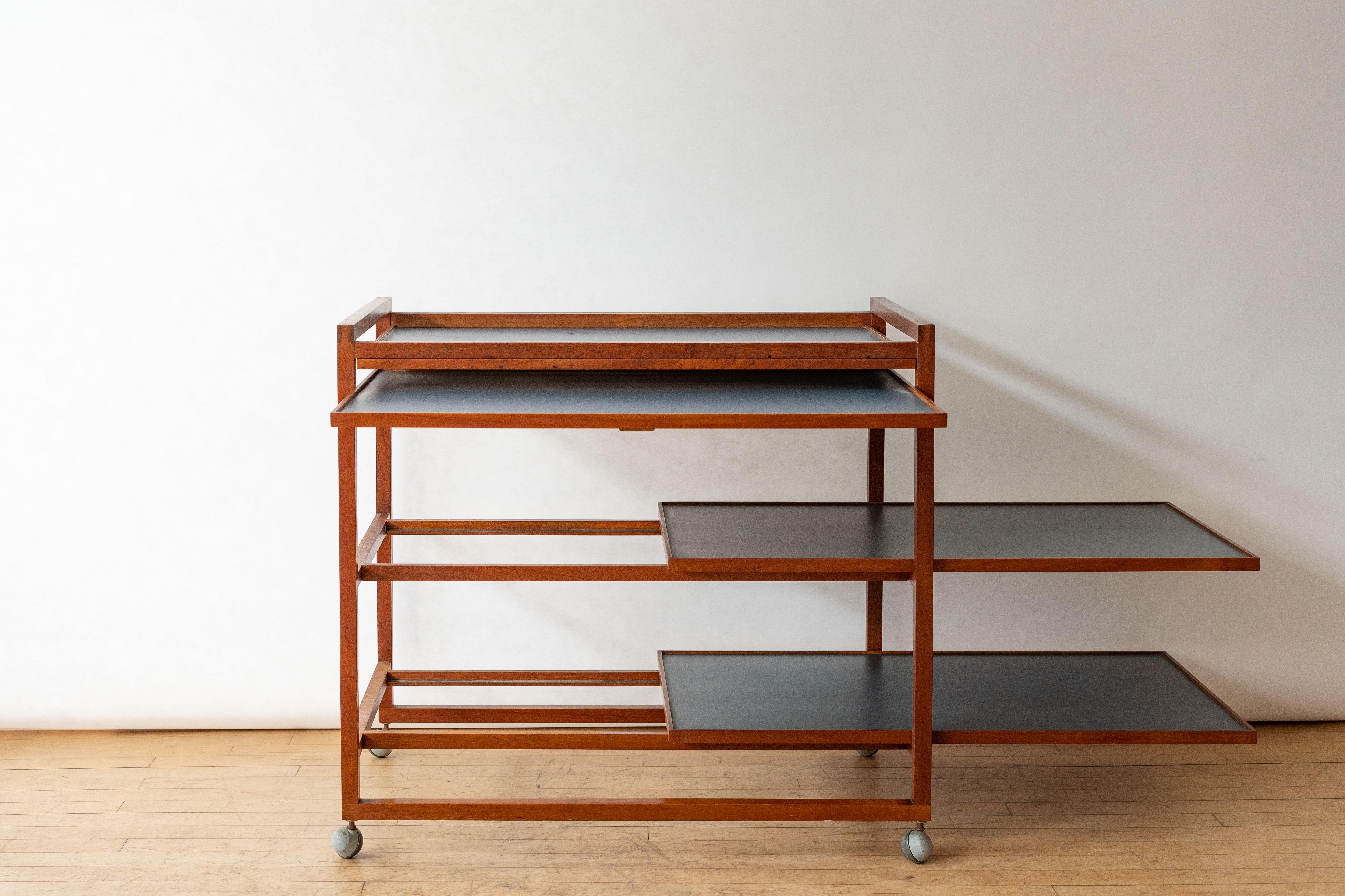 Denmark, ca. 1960s. A handsome bar cart by Niels Erik Glasdam Jensen for Vantinge Møbelindustri. Features solid teak architectural design with three tiers finished in durable slate gray laminate. Clever pull-out surface is ideal for mixing drinks,