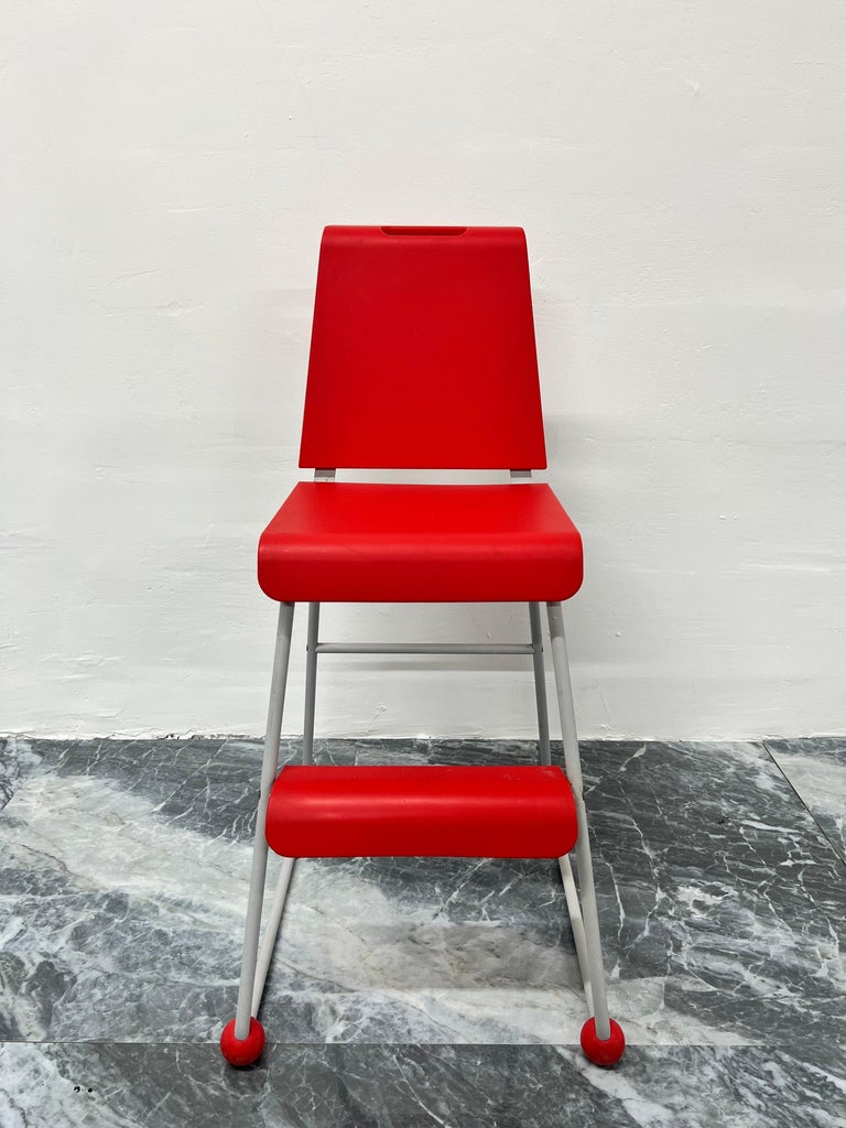 Postmodern Memphis style children's high chair or stool with red plastic seat and footrest on gray powder-coated steel frame designed by Niels Gammelgaard for Ikea, circa 1990s.