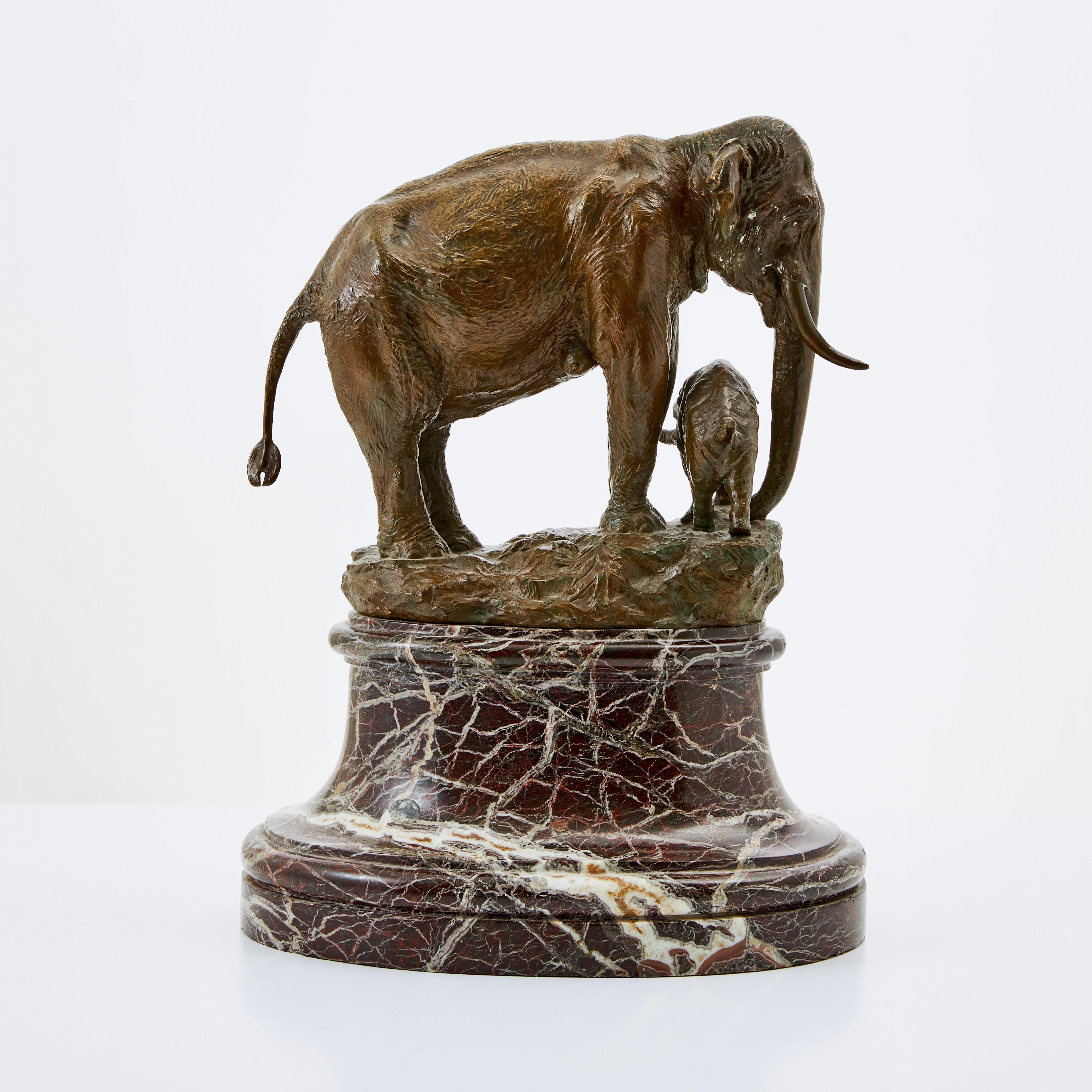 A fine patinated bronze sculpture of a mother elephant with her baby elephant by Niels Holm (1860-1933). Signed NIELS HOLM, ELEPHASINDICUS, ENDANGER. Also signed L. RASMUSSEN, KOBENHAVN which is the foundry. Mounted on a red marble base. 
Niels Holm