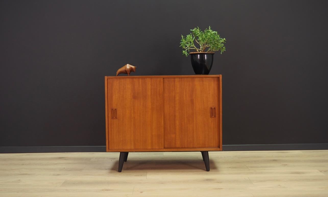 Fantastic cabinet from the 1960s-1970s. Scandinavian design, Minimalist form. Design by renowned Danish designer Niels J. Thorsø. The furniture finished with teak veneer. Shelf behind a sliding door. Maintained in good condition (minor bruises and