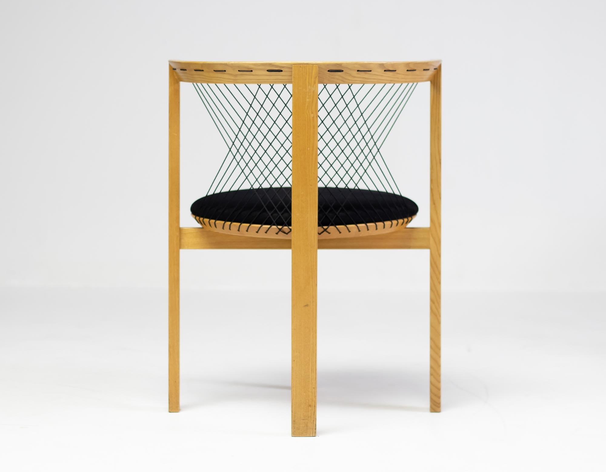 String armchair designed by Niels Jørgen Haugesen for Tranekaer in Denmark.
Very smart and comfortable design. Because the 4 legs are configured with one leg in front, the person sitting on the chair can move his/her legs around freely. The