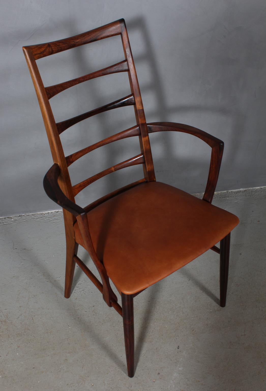 Niels Koefoed armchair made in solid rosewood.

New upholstered in vintage tan aniline leather.

Model Lis, made by Niels Koefoeds Møbelfabrik Hornslet, 1960s.
   
 