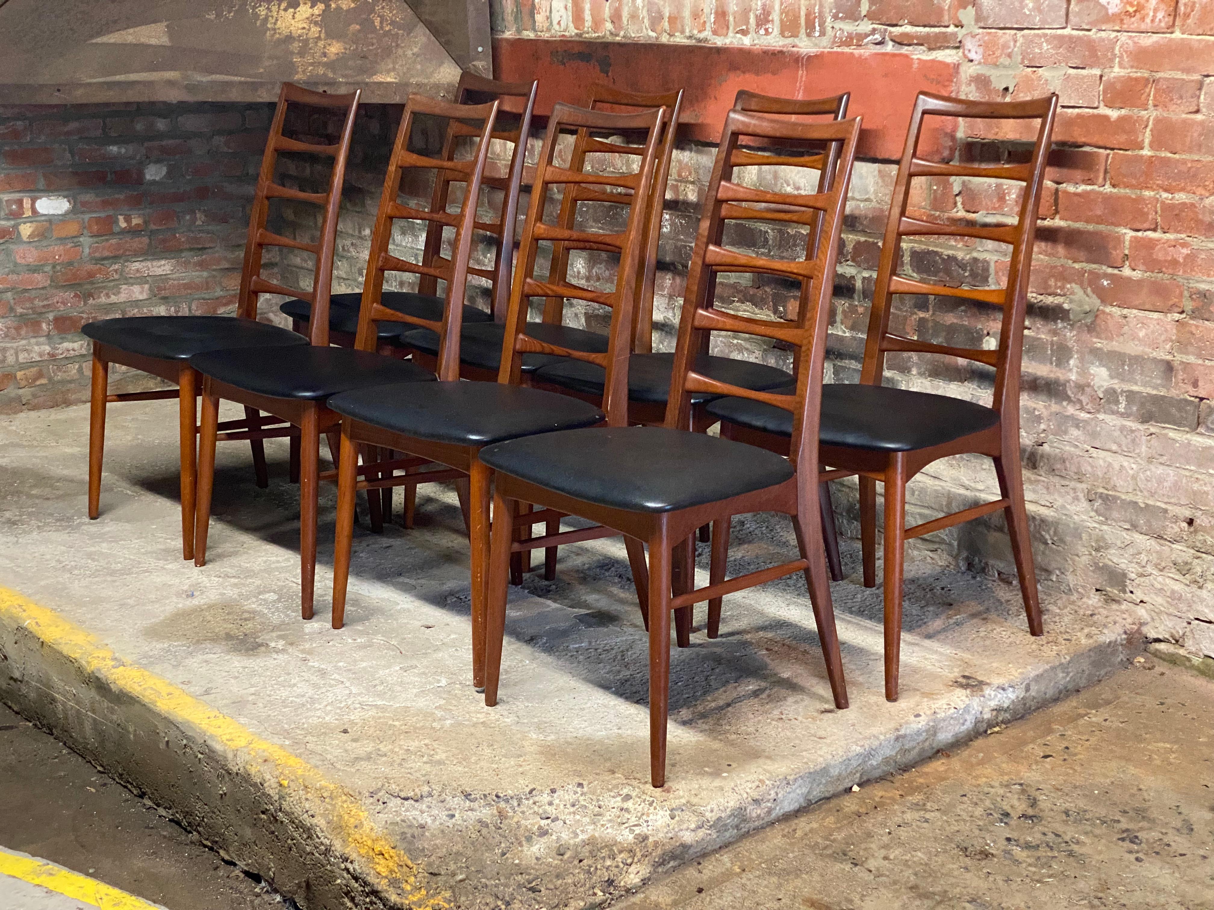 Set of eight Niels Koefoed for Koefoeds Hornslet Lis teak ladder back dining chairs. Beautiful and elegant arched ladder back chairs. Signed with Danish Control stamp and the original Bloomingdale's Bros. tag. Featuring tapered legs, stretcher