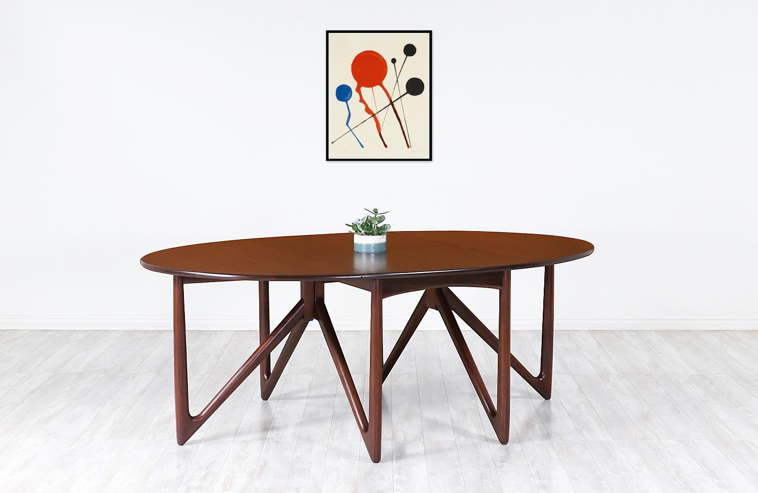 Versatile dining table designed by Danish designer Niels Koefed in collaboration with the workshop of Koefoeds Møbelfabrik during the 1960s. Crafted from Brazilian rosewood, this table functions as a console, writing, or dining table with a