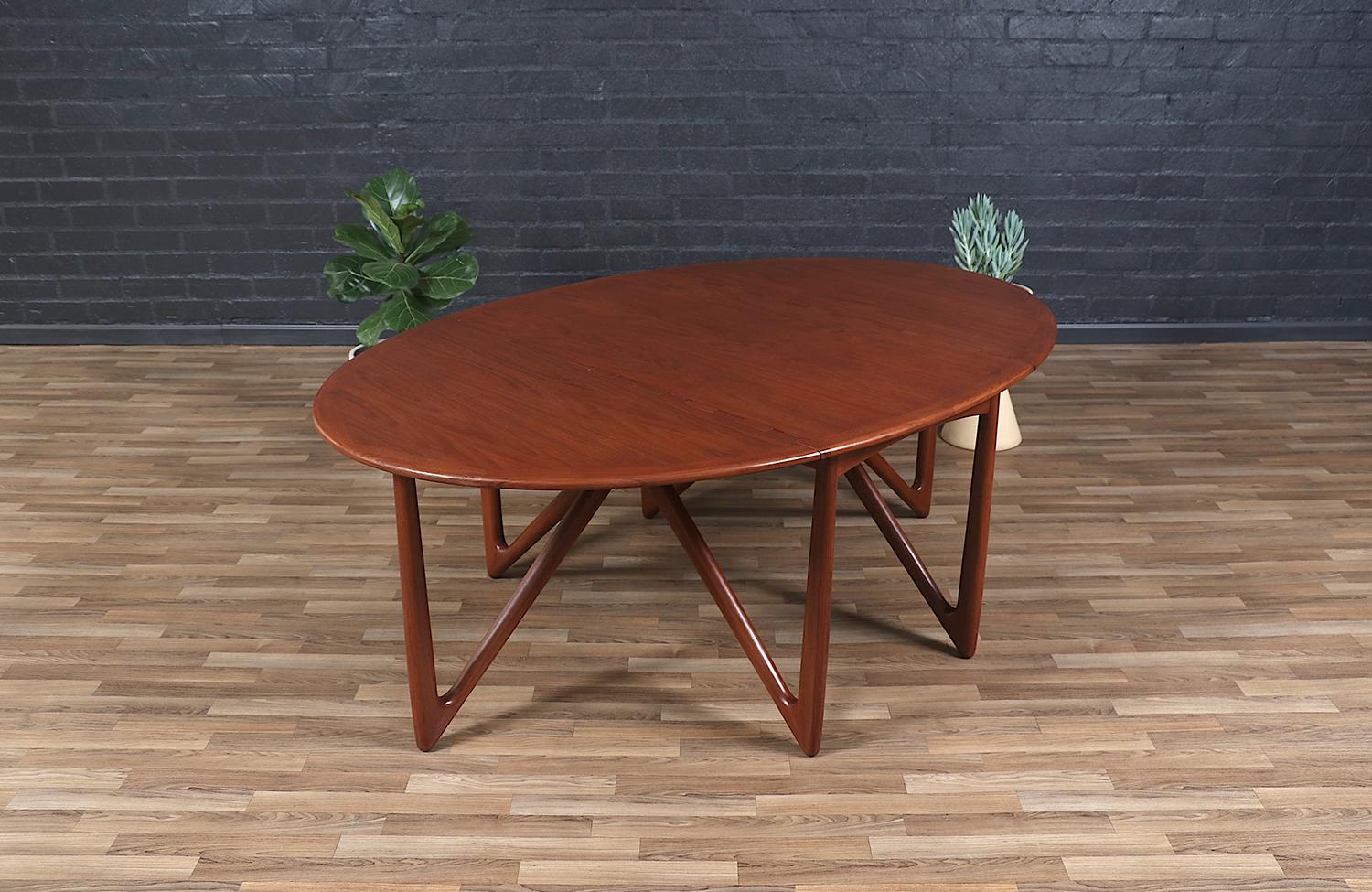 Versatile dining table designed by Danish designer Niels Koefed in collaboration with the workshop of Koefoeds Hornslet during the 1960s. Crafted from teak, this table functions as a console, writing, or dining table with a practical approach to