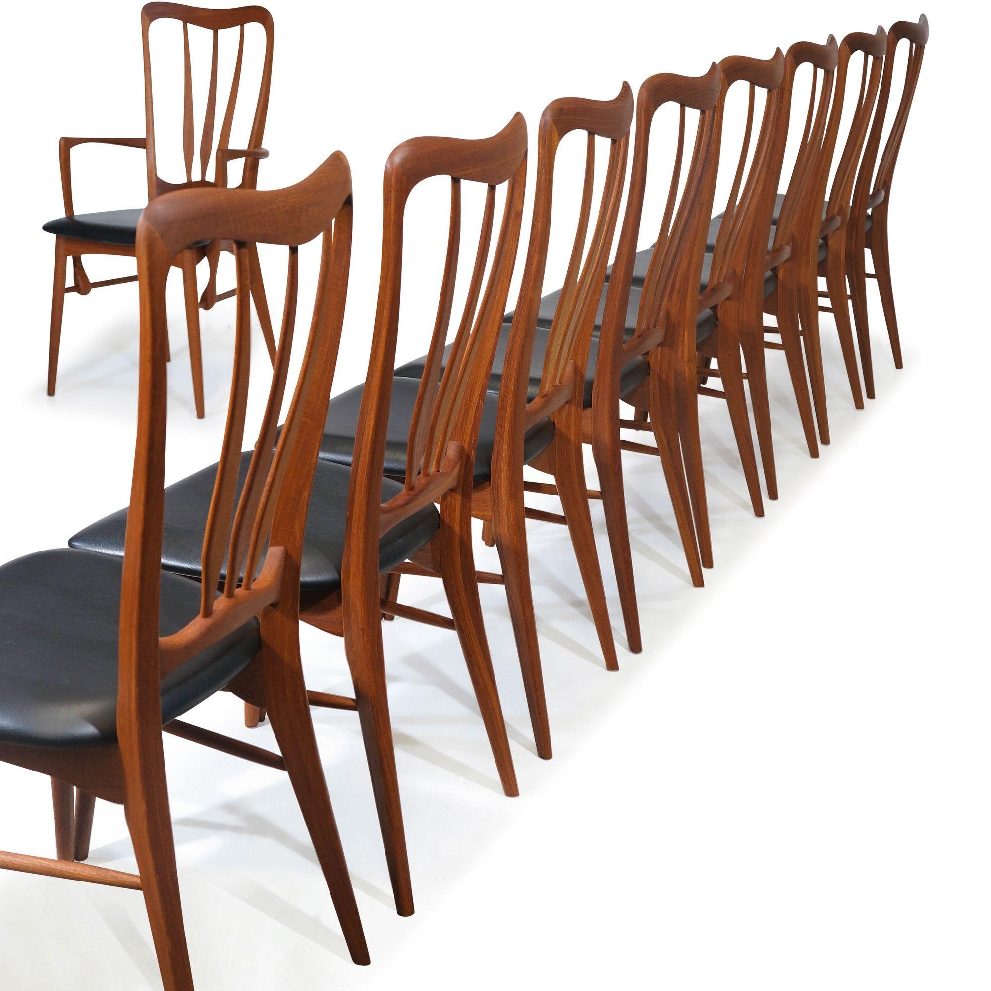 Set of 10 'Ingrid' dining chairs designed by Niels Koefoed for Koefoeds Hornslet, crafted of solid teak with a dramatic sculpted form. The elegant Scandinavian set includes eight side chairs and two armchairs, all with original black vinyl