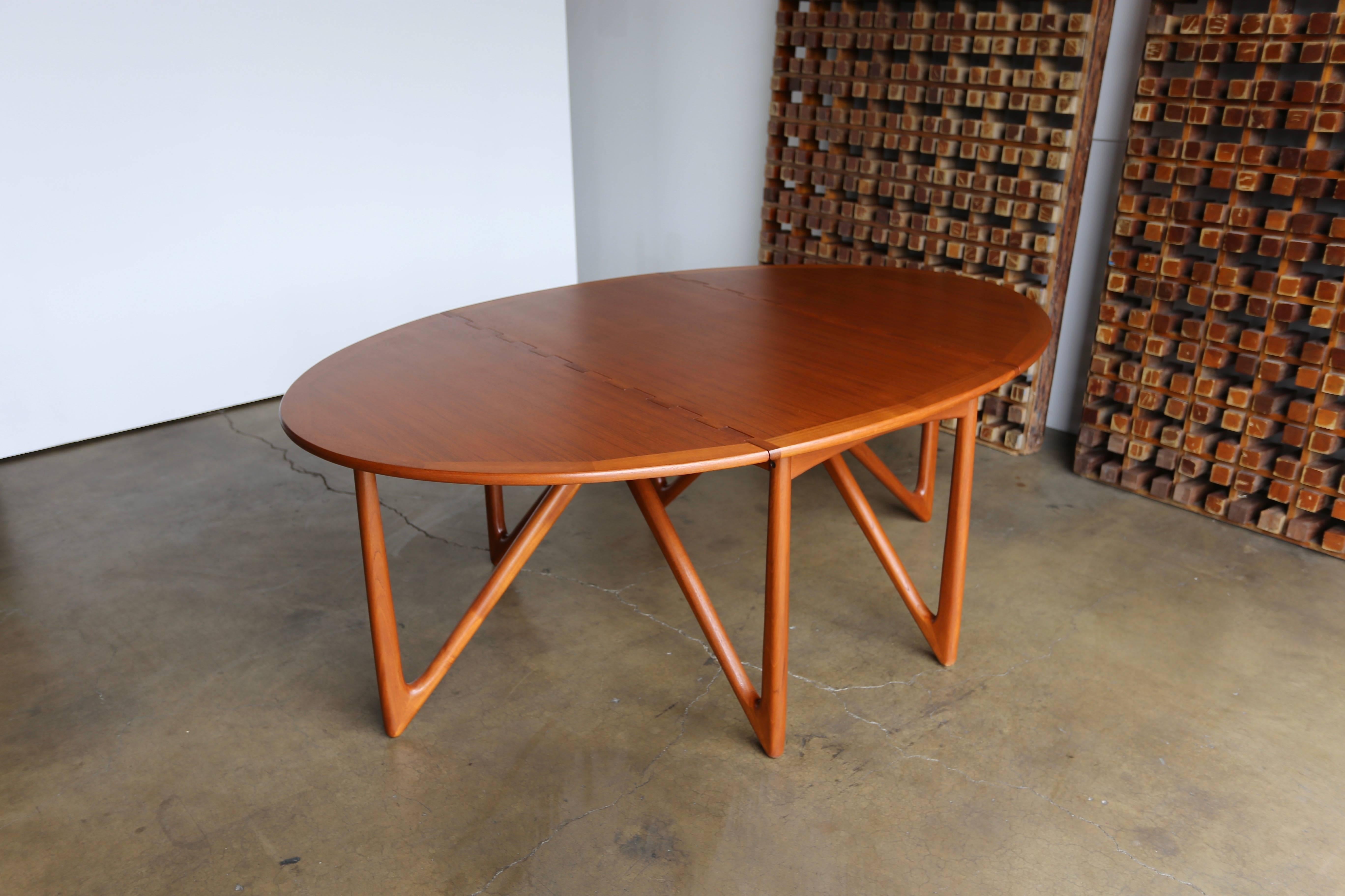 Niels Kofoed teak gate-leg dining table. This multifunctional piece can be used as a console, writing or dining table. This table has been professionally restored.