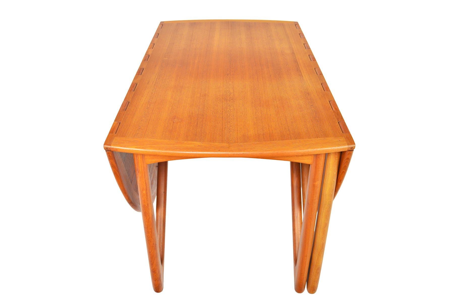 This Danish modern drop leaf dining table model 304 was designed by Niels Kofoed for Kofoed Møbelfabrik in the mid-1960s. This stunning table features two drop leaves which are supported by the articulating “gateleg” design. Restoration to top is