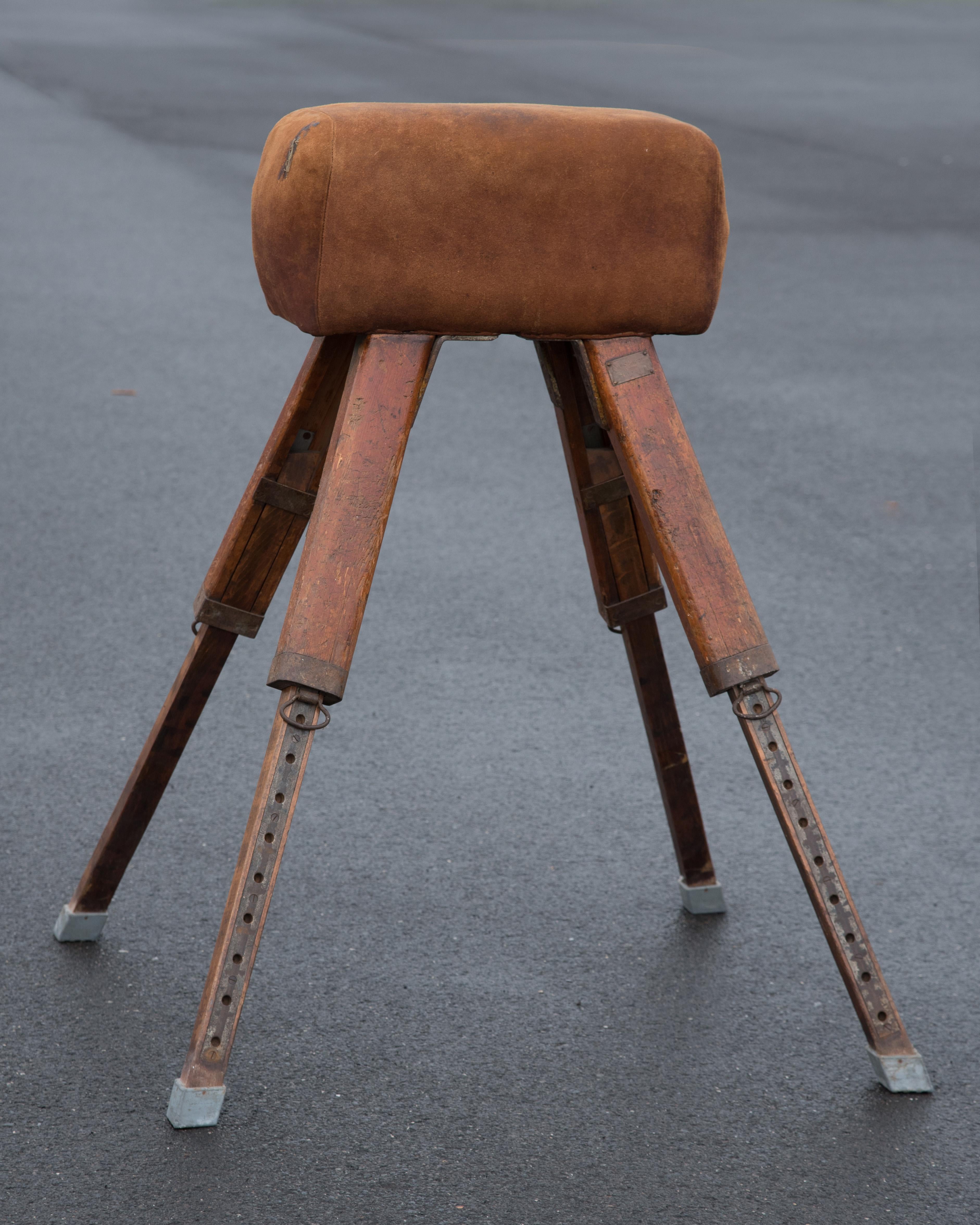 A rare original early 20th century vaulting pommel horse in brown suede leather by Niels Larsen & Sons. The original suede has a wonderful, warm brown color and patina. There is an old glue and stitch repair on one side which adds to the character