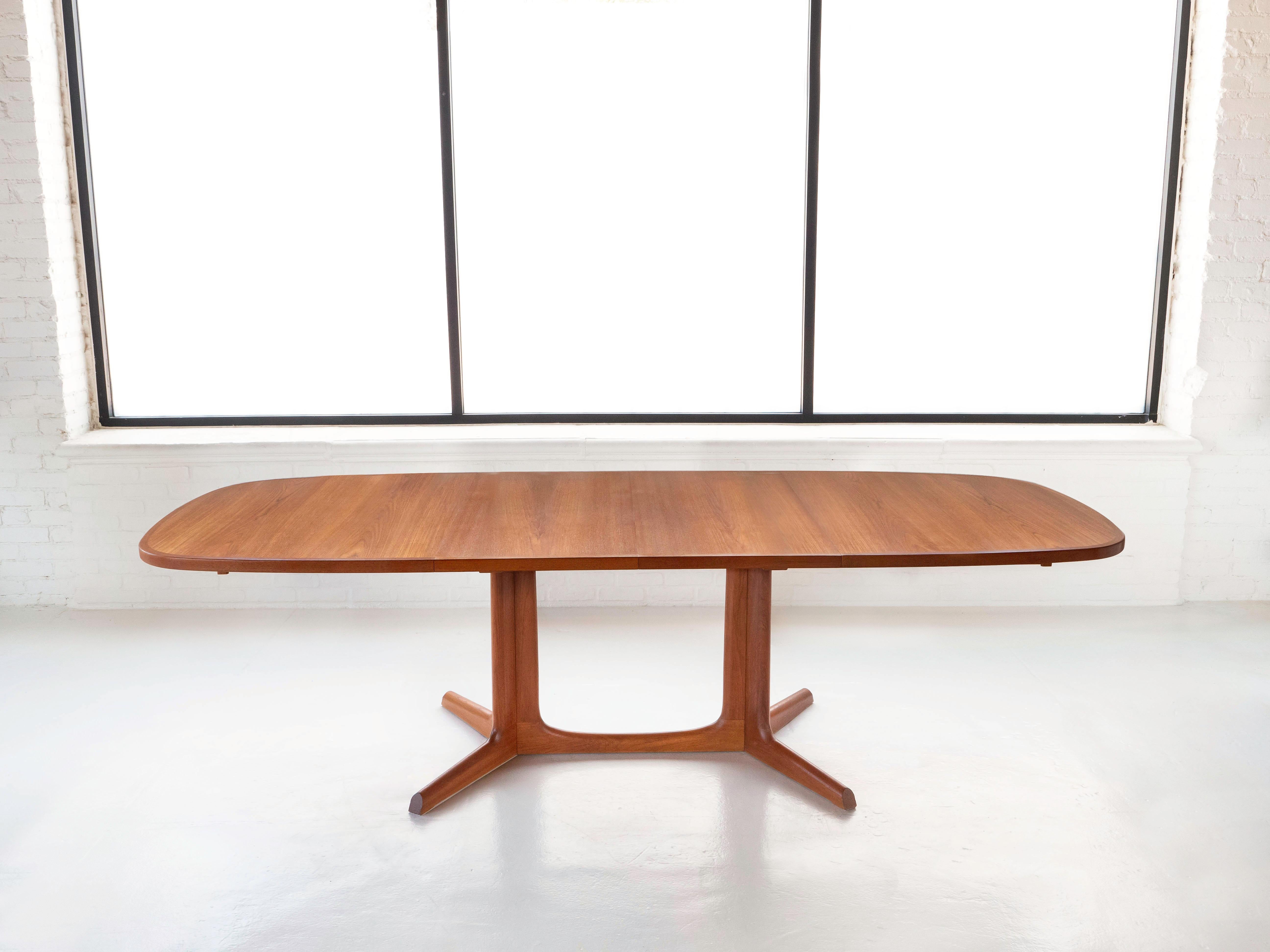 Teak dining table with two leaves by designer Niels O. Moller for company Gudme Mobelfabrik. Made in Denmark circa 1960's. The tables leaves can be stored beneath the table when not in use. This table is an earlier version than many of the others