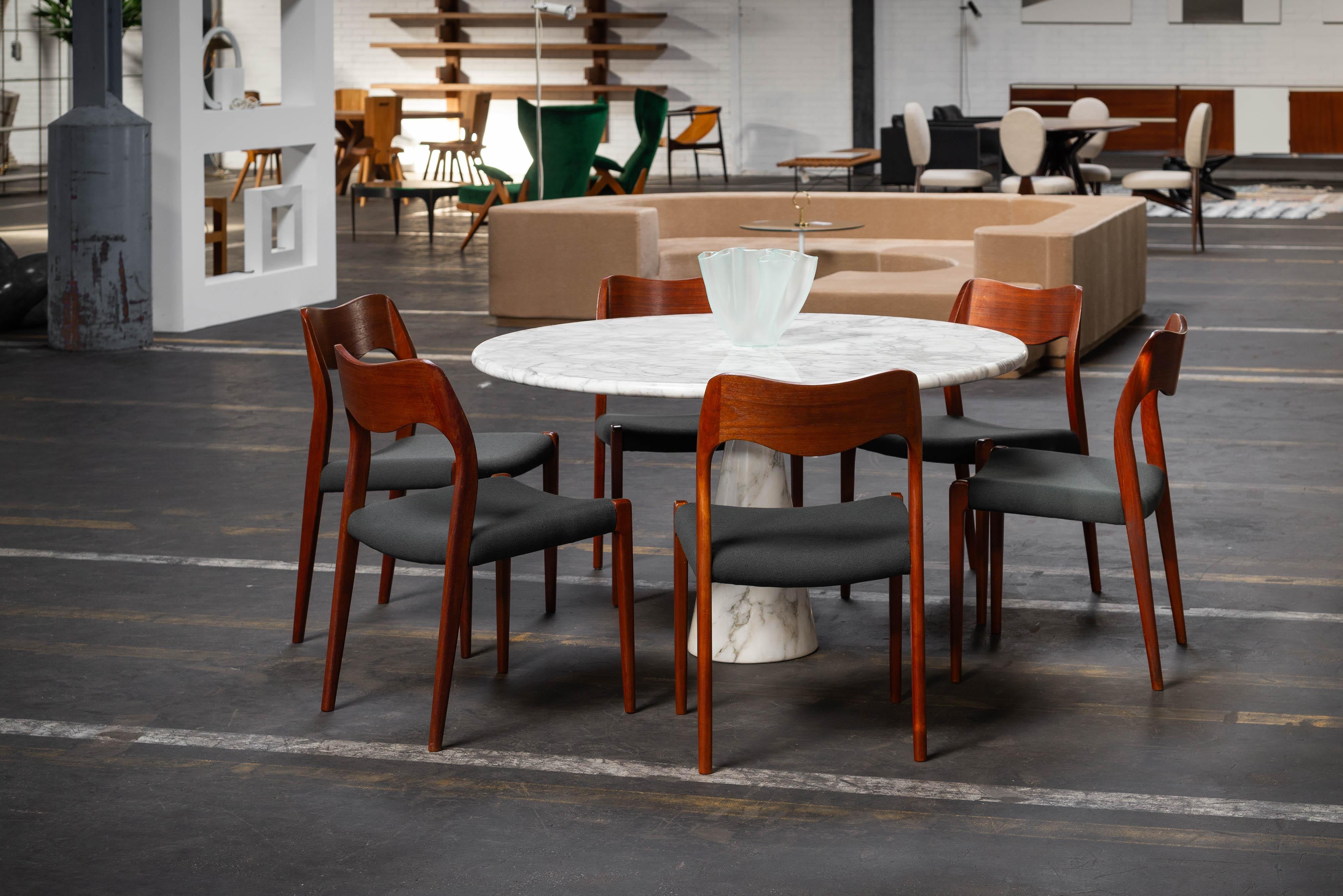 Exceptionally large set of 12 Model 71 chairs designed by Niels Otto Møller and manufactured by J.L. Møller Møbelfabrik in Denmark in 1951. These chairs are not only beautiful but also very practical. They're crafted from solid teak wood and have a