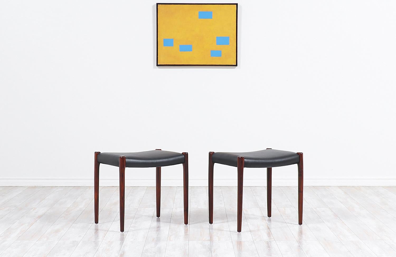 Set of two Minimalist stools designed by Niels O. Møller for his family-owned company J.L. Møllers in Denmark during the 1960s. Both stools feature an ergonomic design and are comprised of solid rosewood with new Italian leather upholstery and
