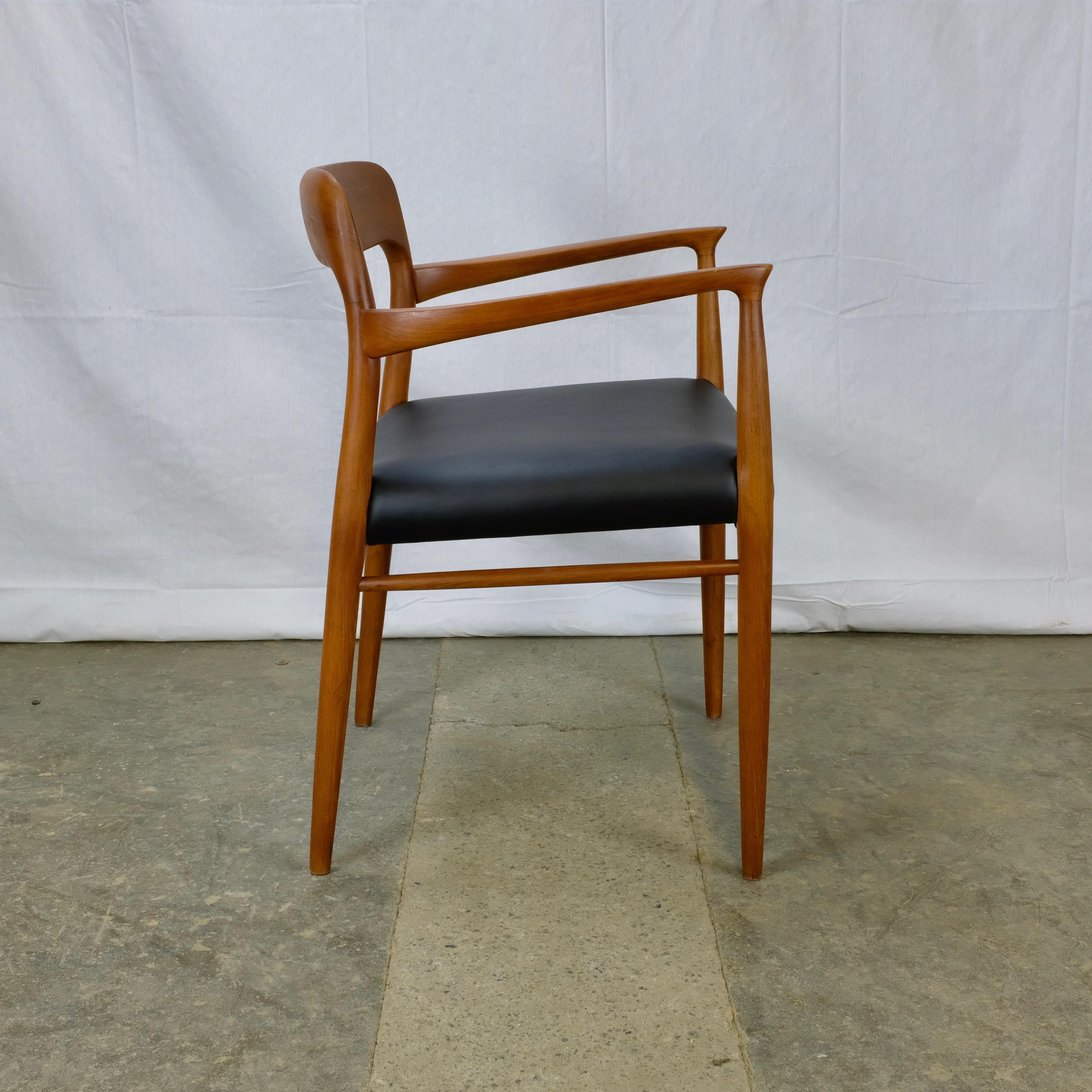 Model 56 armchair designed by Niels Otto Møller and made in Denmark by J.L. Møllers Møbelfabrik. The chair matches Møller's model 75 dining chairs 

The solid teak frame has been fully refinished while the seat has been reupholstered in black