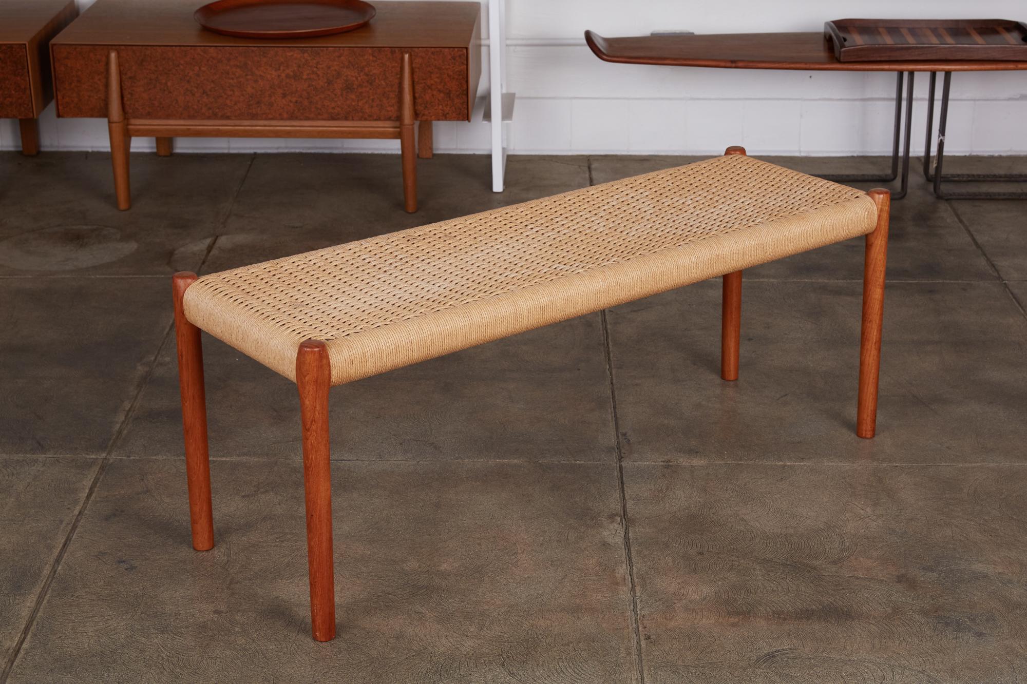 Niels Møller's teak and woven cord bench for his family’s company, JL Møllers Møbelfabrik, Denmark, circa 1960s. The bench features an oiled teak frame and legs with Danish cord upholstery. Danish cord three-ply, a twisted paper of superior strength