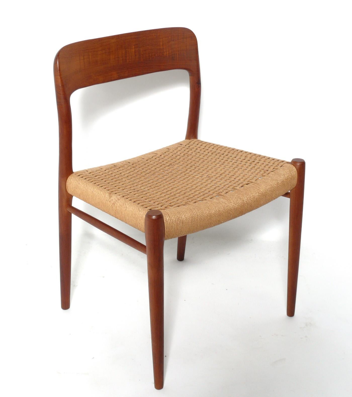Set of four Danish modern dining chairs, designed by Niels Moller, Denmark, circa 1960s. The teak frames have been cleaned and Danish oiled, and the woven rope seats retain their warm original patina. The price noted is for the set of four chairs.