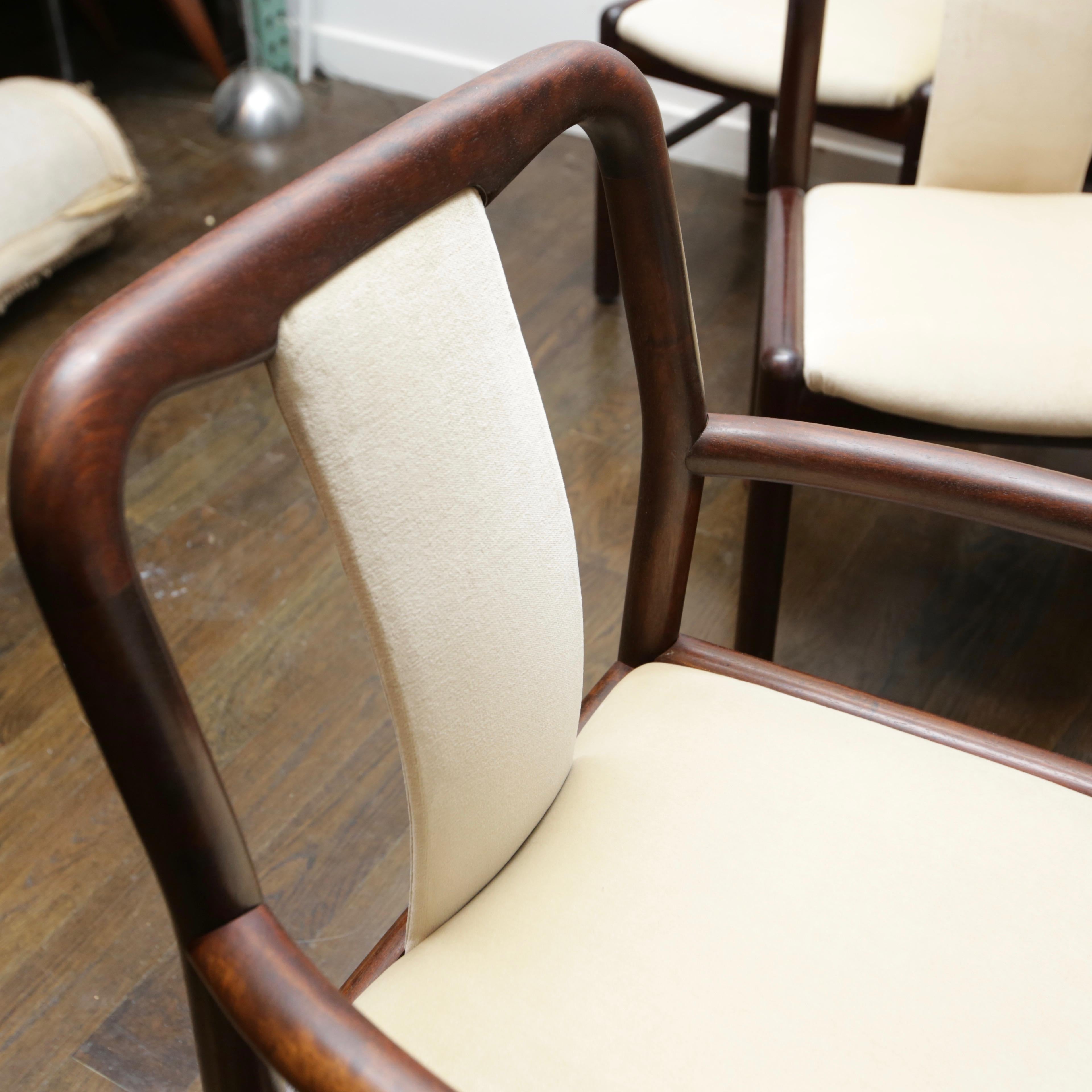 Newly reupholstered set of Danish modern rosewood dining chairs from the 1960s. Chairs are solid rosewood and well constructed. Armchairs are 24