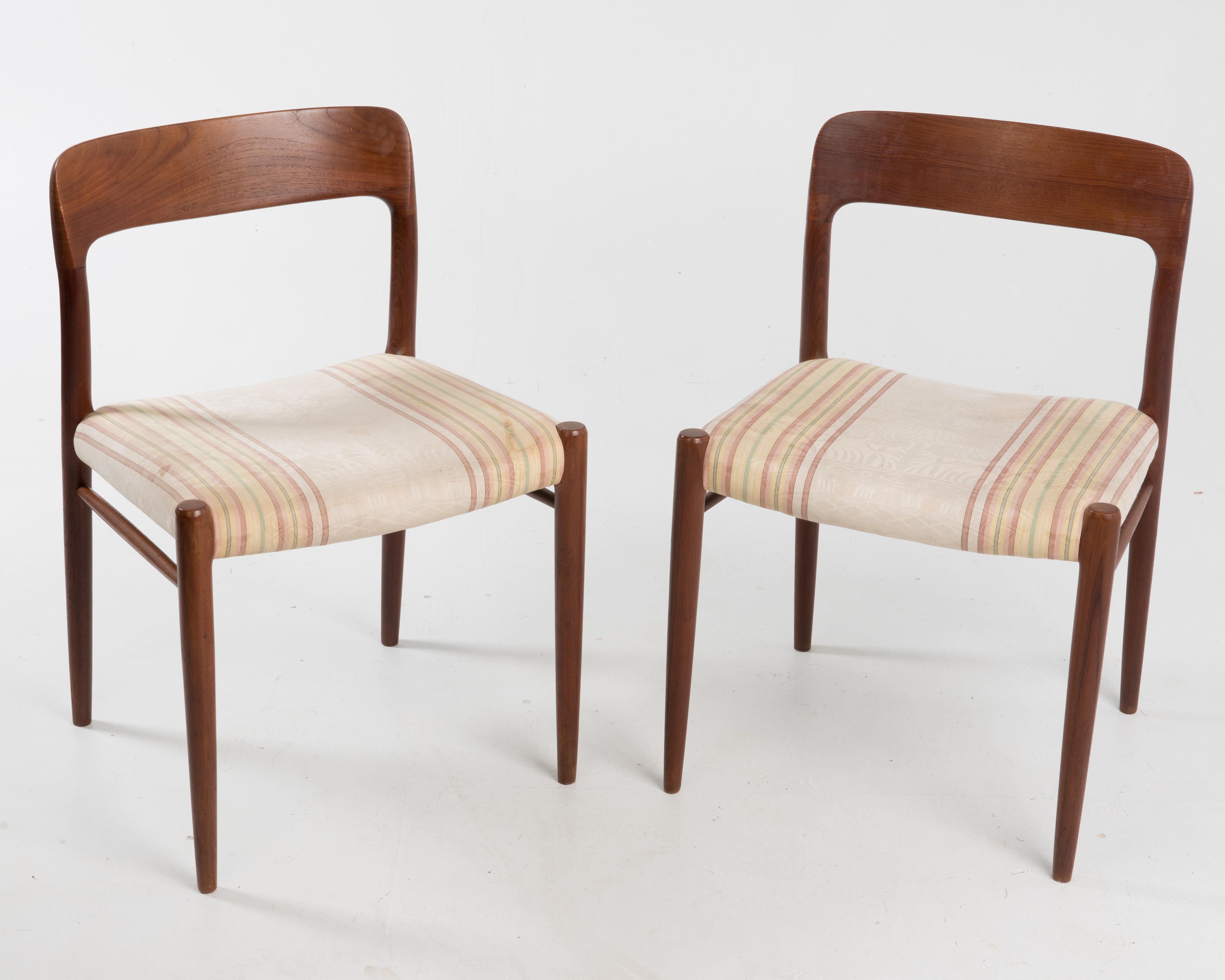 Pair of Niels Moller model 75 dining or side chairs, 1960s. Solid teak frames with fabric seats. The seats appear original, at the very least the fabric has been in place a very long time. The chairs are unmarked, we think the mark is hidden by the