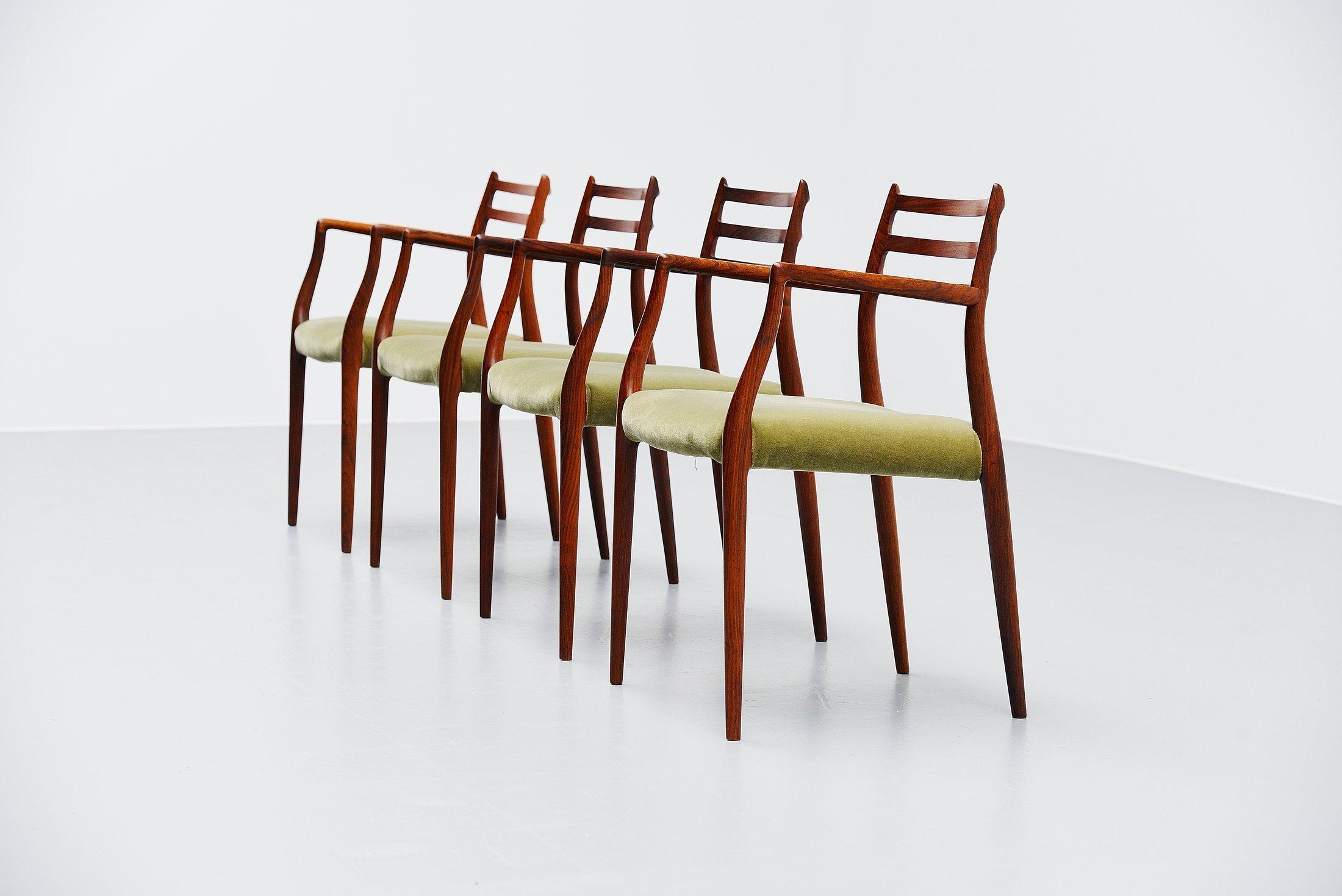 Amazing set of 4 armchairs model 62 designed by Niels Møller and manufactured by J.L. Møller Møbelfabrik, Denmark 1962. This is for a rare solid rosewood armchair with reupholstered green velvet seating. For sure the nicest design by Møller. The