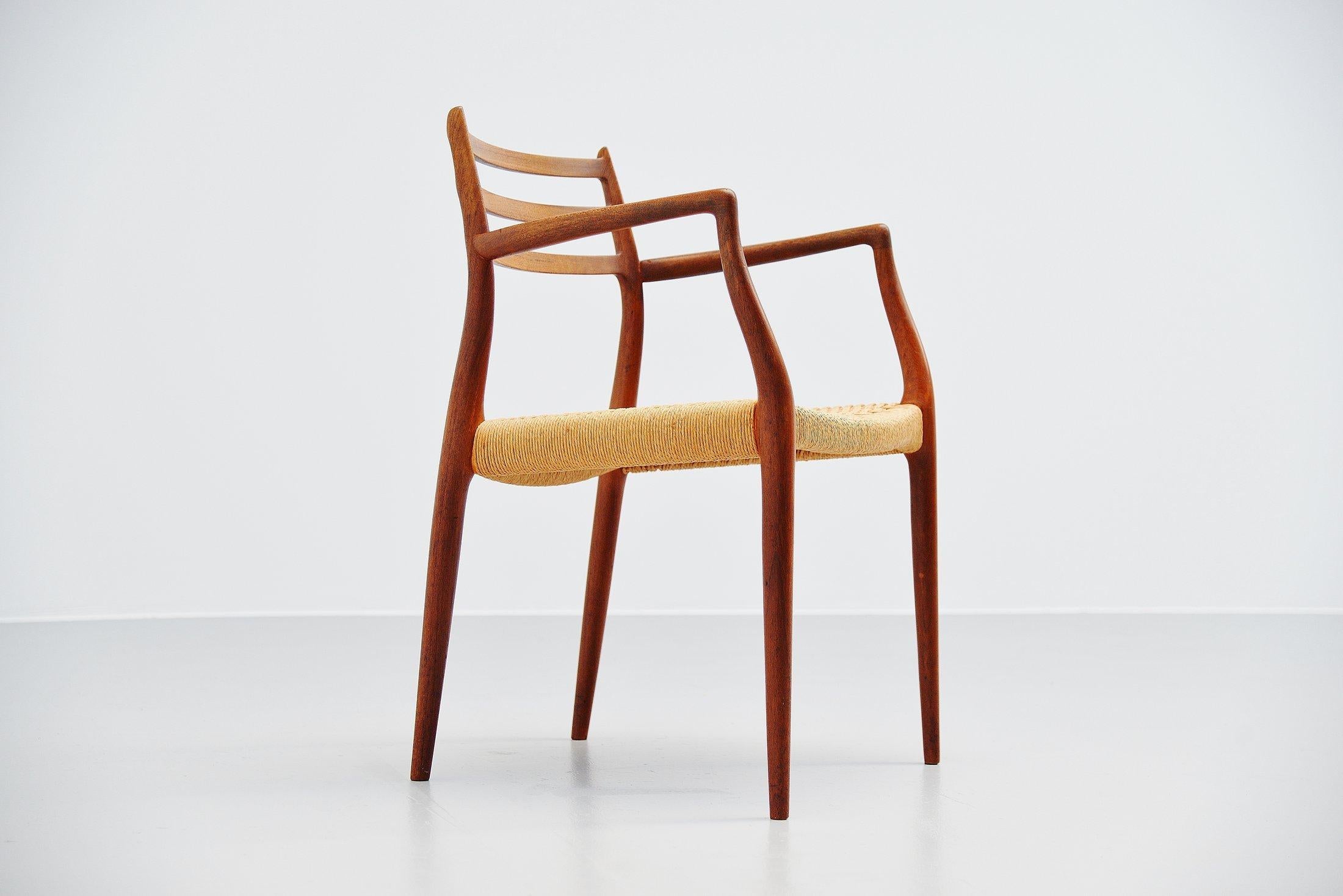 Fantastic armchair model 62 designed by Niels Moller and manufactured by J.L. Moller Mobelfabrik, Denmark, 1962. This is for a rare solid teak armchair with original papercord seat. For sure the nicest design by Moller. The appearance this chair has