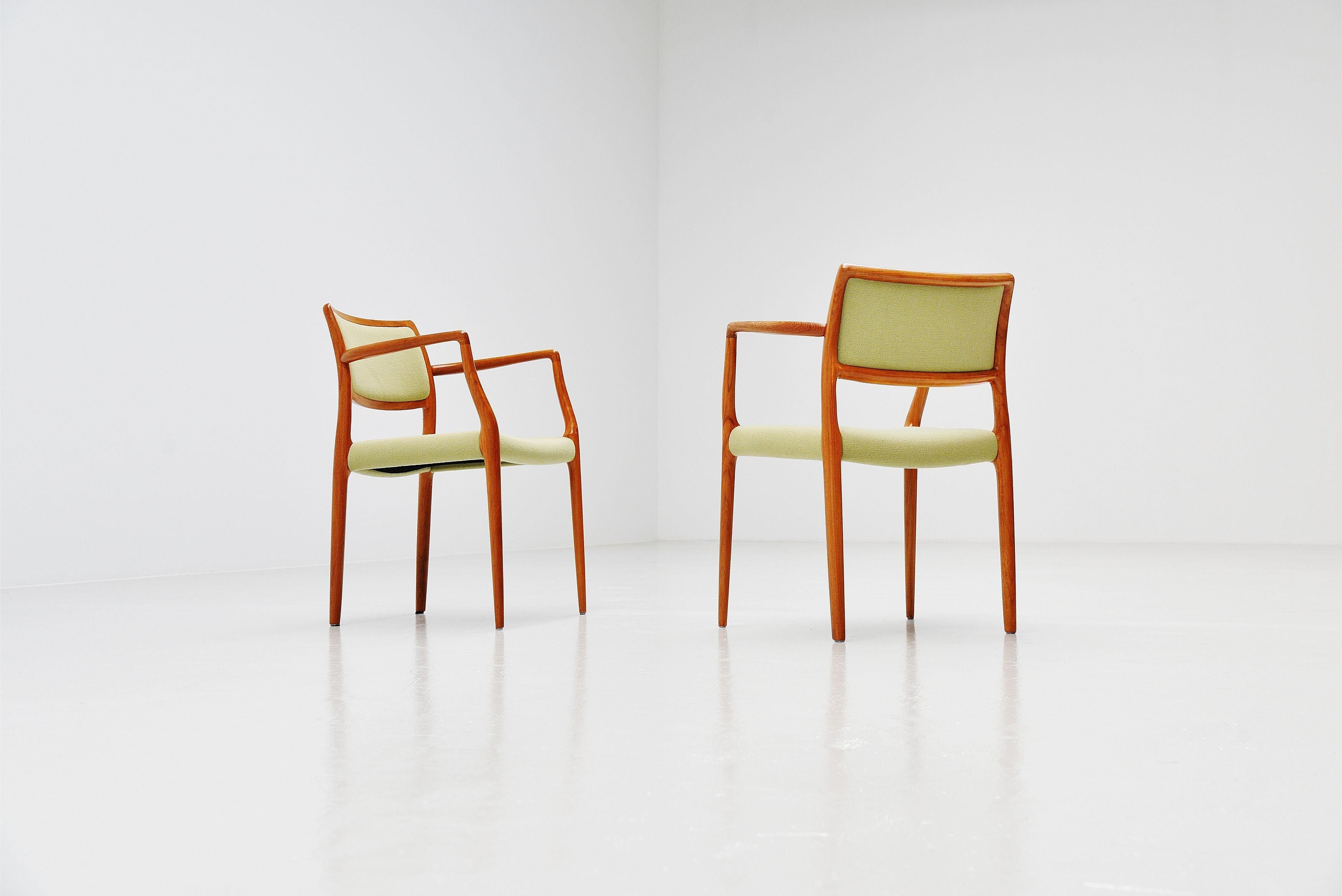 Fantastic shaped and pair of armchairs model 65 designed by Niels Moller and manufactured by J.L. Møller Mobelfabrik, Denmark 1968. These chairs have a solid teak frame and mint green upholstered seats and backs which is still original but is