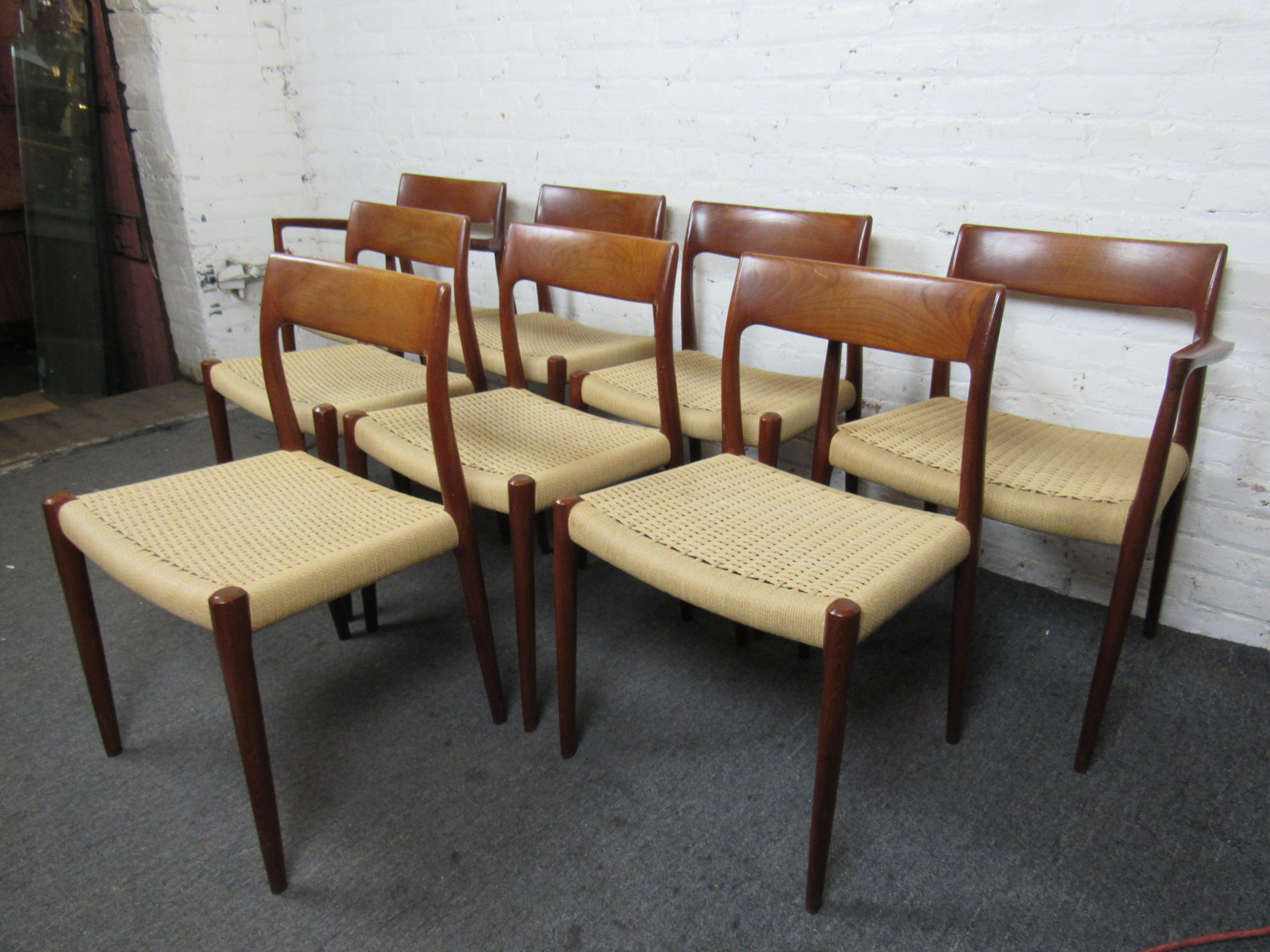 This set of eight teak dining room chairs by Møller offer the understated style and craftsmanship characteristic to Mid-Century Danish design. Two chairs with arms can be placed at either end of a dining table, while six other chairs complete the