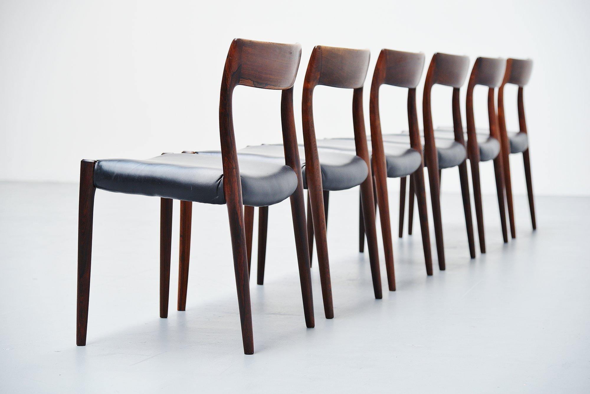 Very nice set of 6 rosewood dining chairs model 77 designed by Niels Moller and manufactured by J.L. Møller Mobelfabrik, Denmark 1959. These chairs are made of solid rosewood wood and have newly upholstered black leather seats that shows a very nice