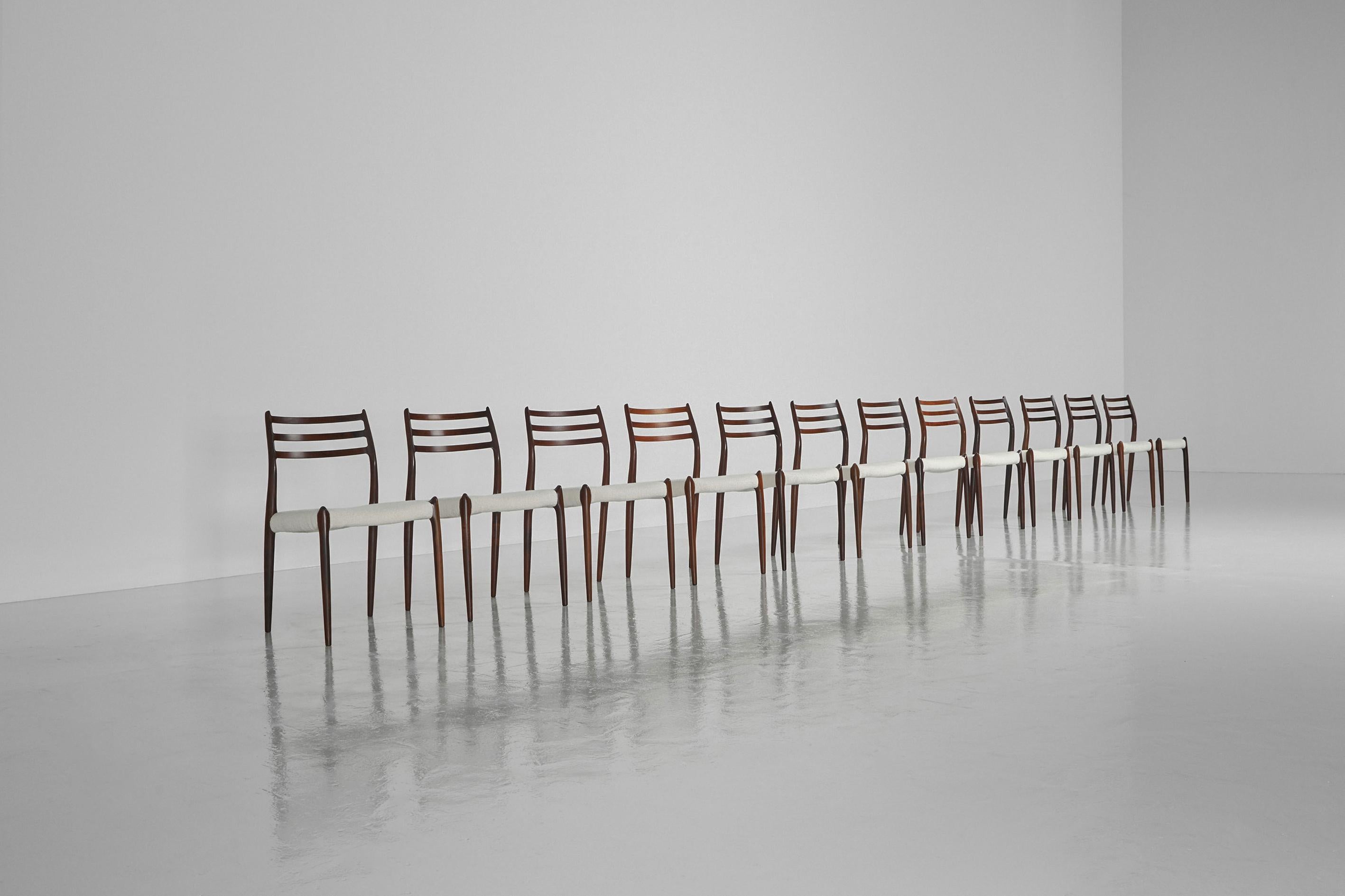 Sculptural and large set of 12 dining chairs model 78 designed by Niels O. Moller, manufactured by J.L. Møller Mobelfabrik, Denmark 1962. These lovely shaped chairs are made of solid rosewood and are newly upholstered in off white flat bouclé