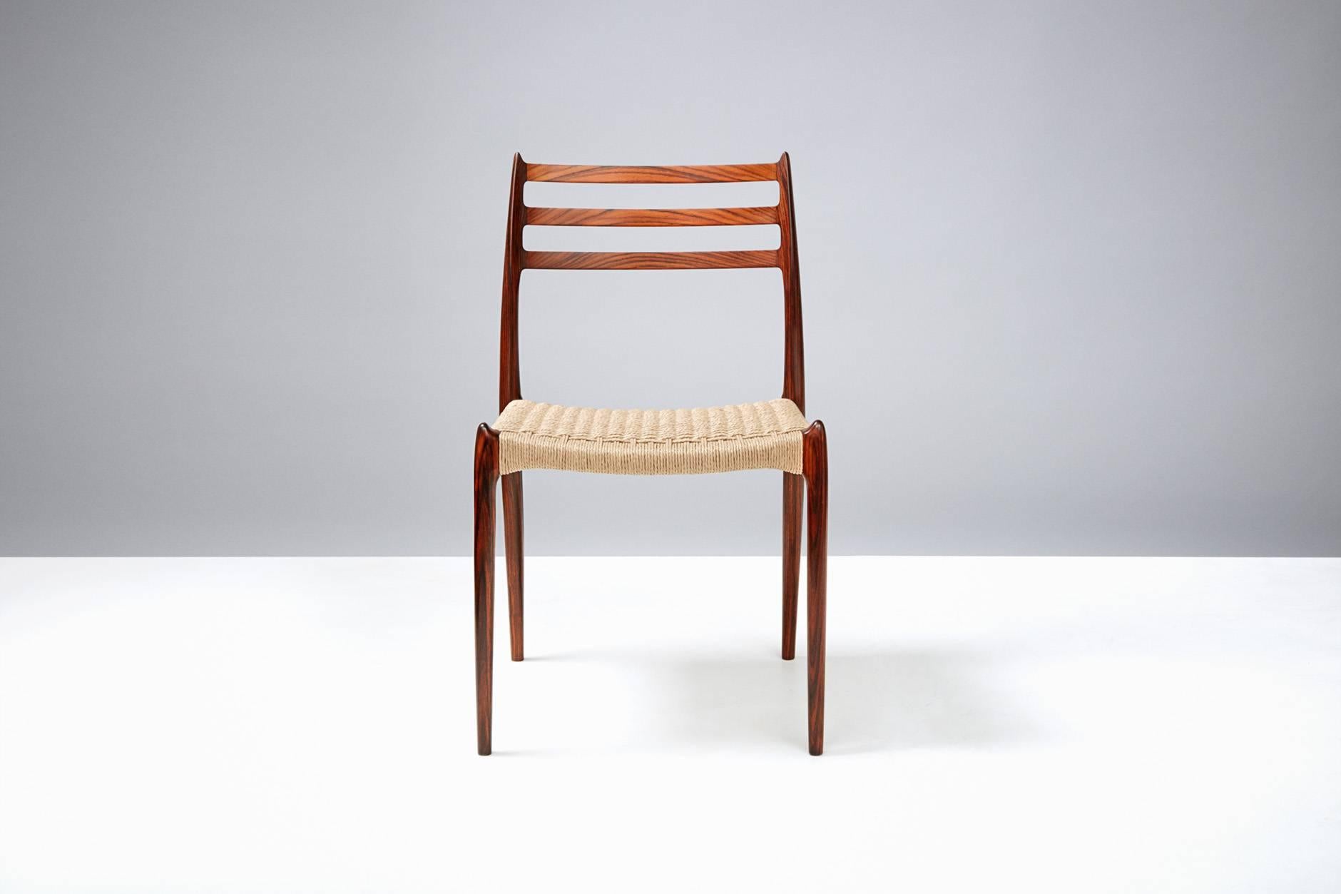 Set of eight rosewood dining chairs with newly woven Danish papercord seats. Designed by Niels O. Moller for J.L. Moller Mobelfabrik, Denmark, 1962. 

 
