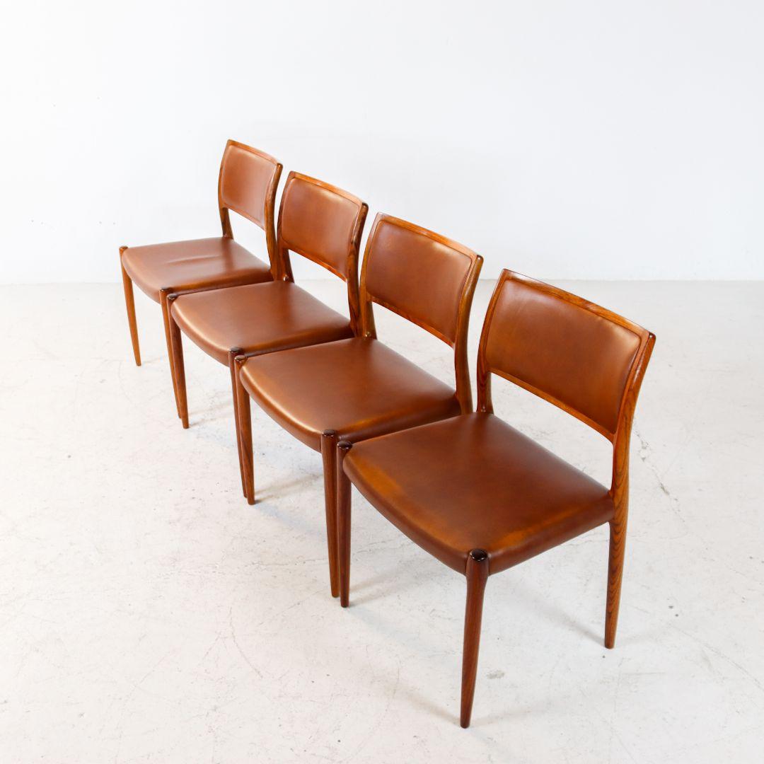 A very nice set of 4 rosewood dining chairs, model 80, designed by Niels Moller and produced by J.L. Møller Mobelfabrik, Denmark, in the 1960s. The chairs feature frames made of luxurious solid rosewood and original brown leather upholstery with a