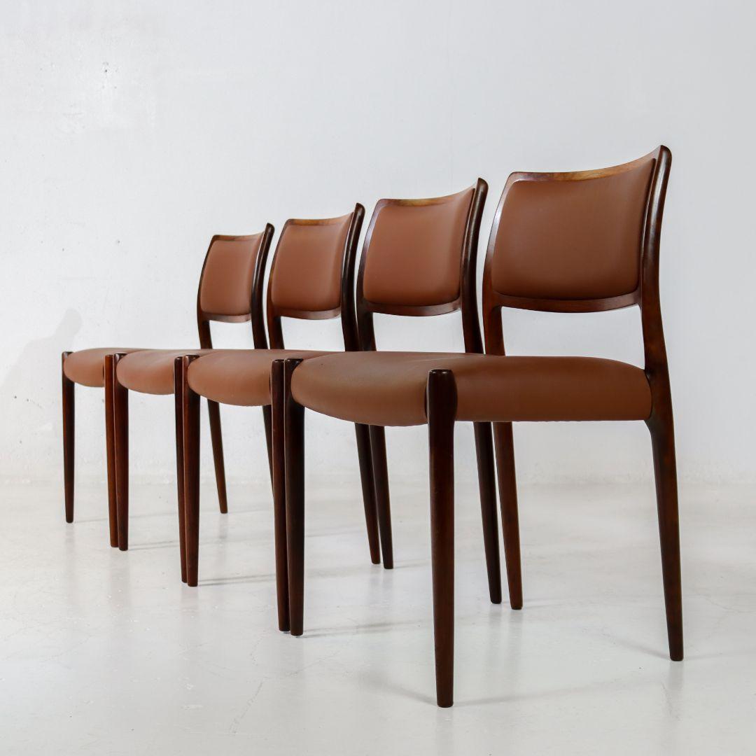 Very nice set of 4 rosewood dining chairs, model 80, designed by Niels Moller in the 1960s and produced by J.L. Møller Mobelfabrik, Denmark in the 1980s. The chairs feature a frame of luxurious solid rosewood and have recently been reupholstered