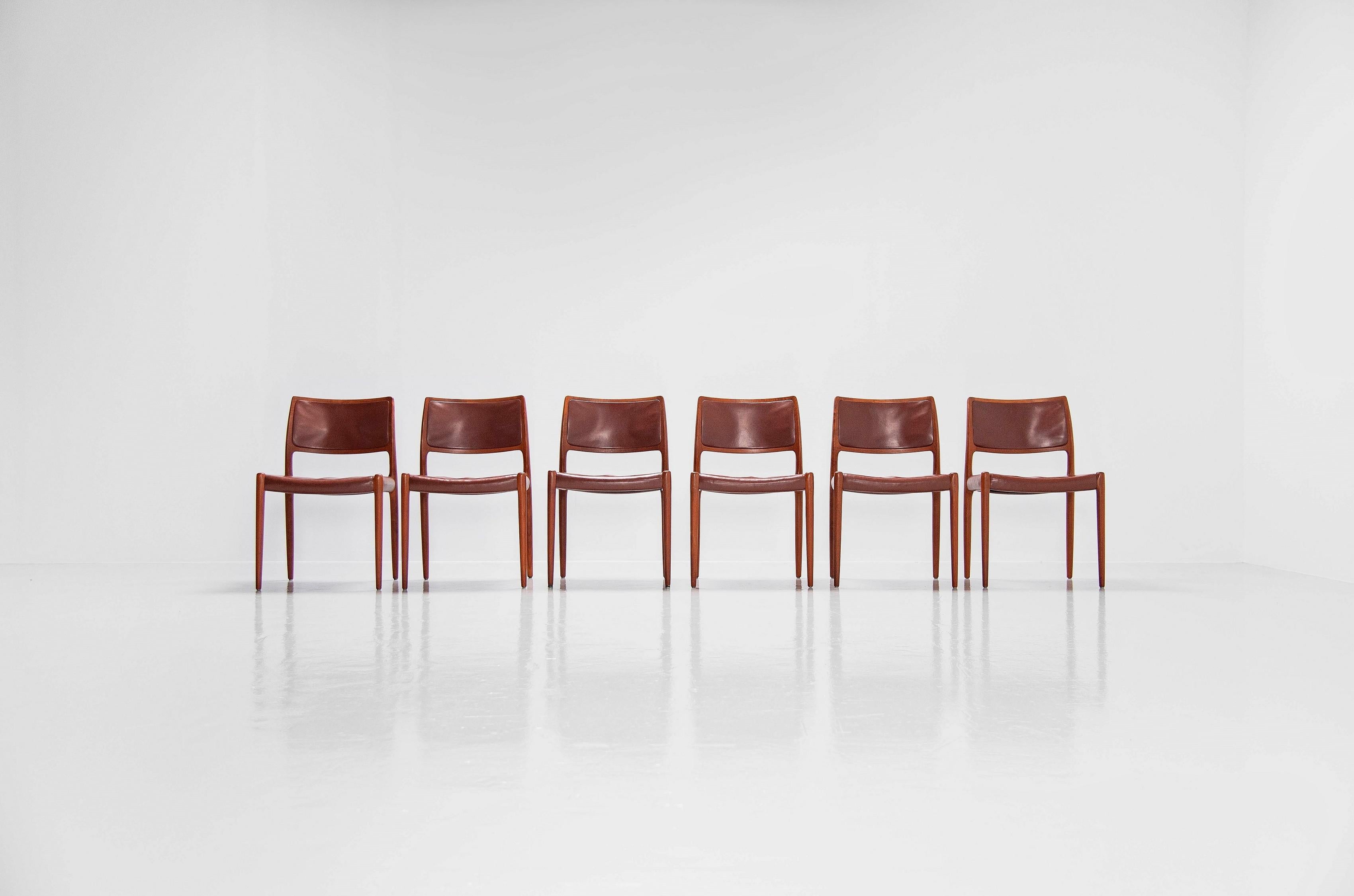 Very nice set of 6 teak dining chairs model 80, designed by Niels Moller and manufactured by J.L. Møller Mobelfabrik, Denmark 1966. The chairs have solid teak frames and original brown leather upholstery with a very nice patina from age and usage.