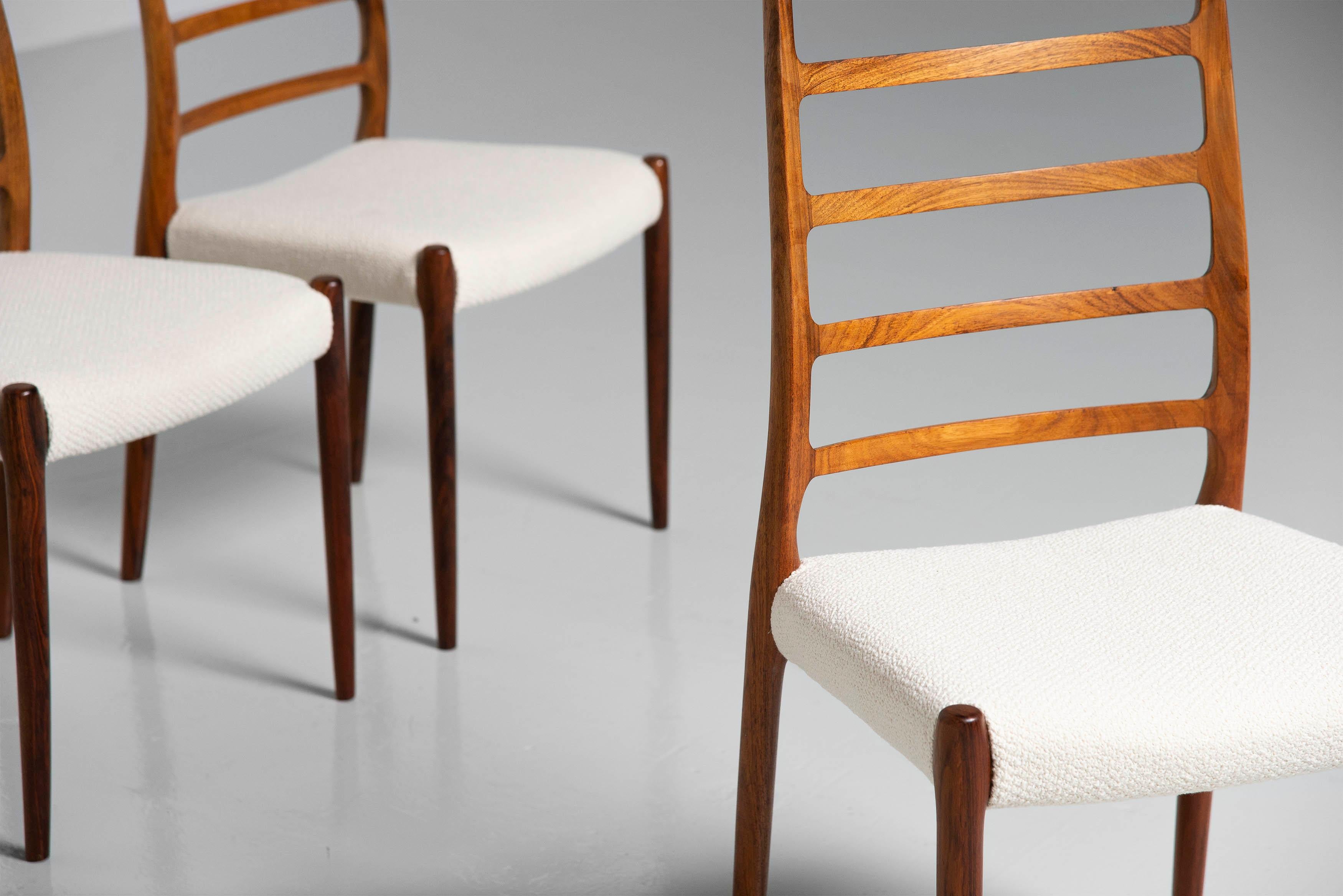 Highly sophisticated set of 6 dining chairs model 82 designed by Niels Moller and manufactured by J.L. Møller Mobelfabrik, Denmark 1971. These chairs are made or rosewood and have newly upholstered off white seats. The rosewood has a beautiful faded