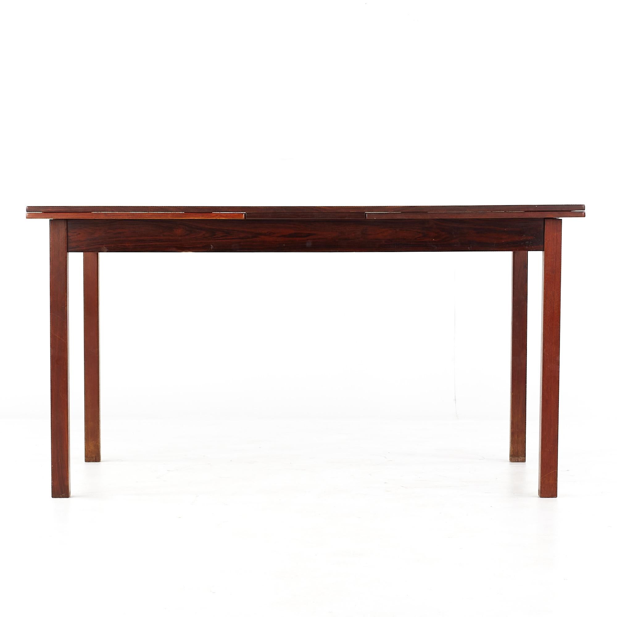 Niels Moller Style Mid Century Rosewood Hidden Leaf Dining Table

This table measures: 55 wide x 35.5 deep x 29 inches high, with a chair clearance of 24.5 inches

All pieces of furniture can be had in what we call restored vintage condition. That