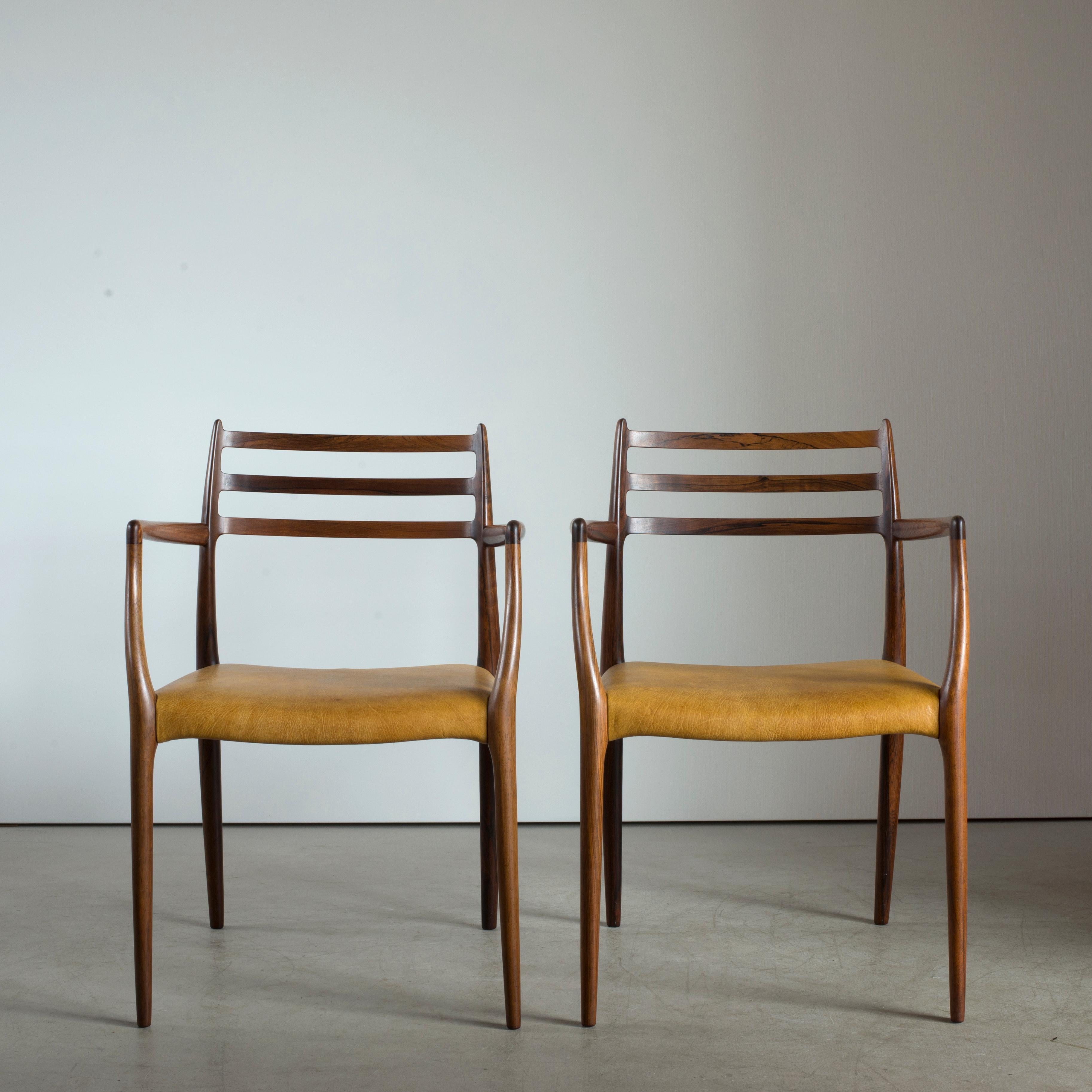 A pair of Brazilian rosewood armchairs, upholstered in seats with leather. Executed by J. L. Møller, Denmark.