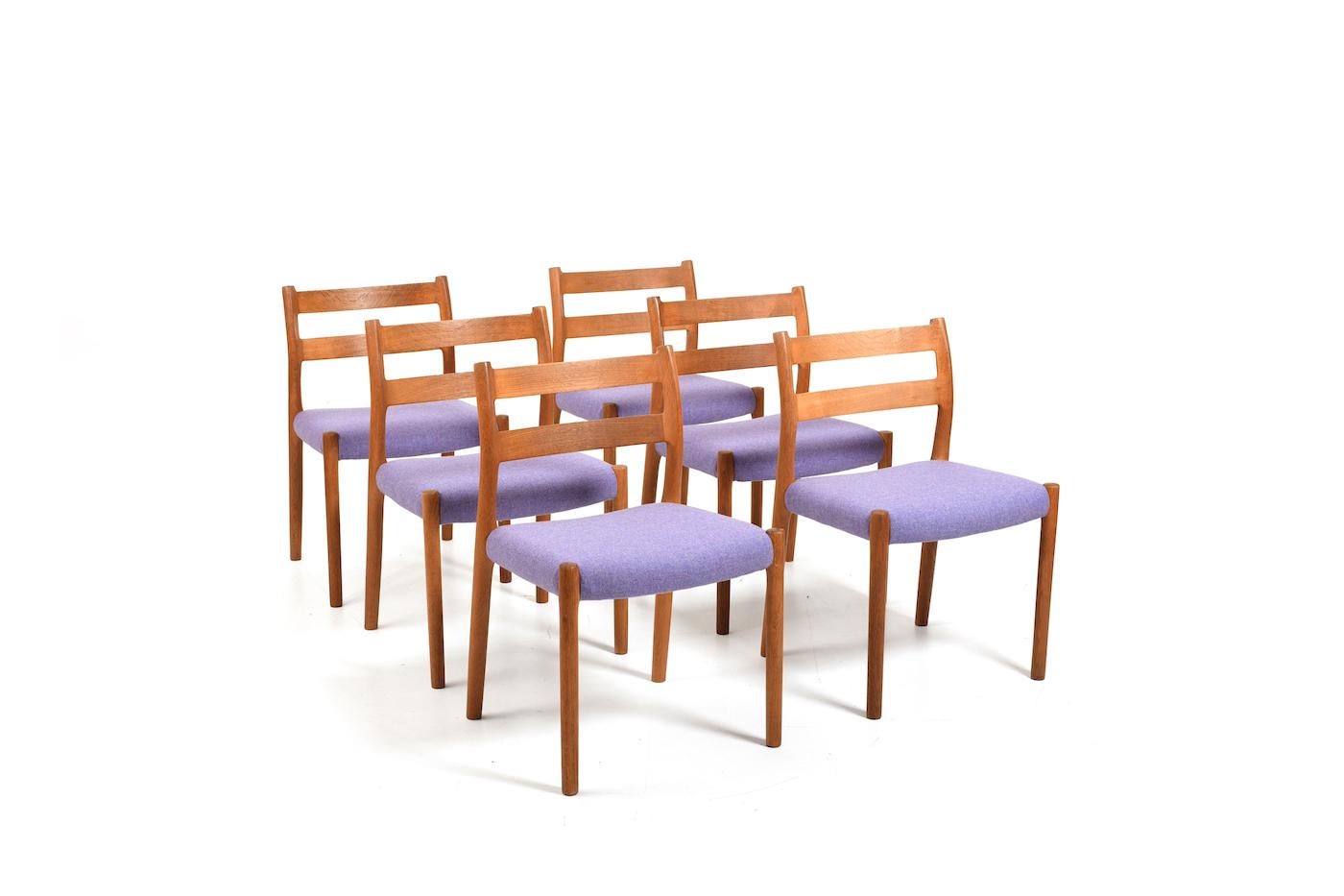 Niels O. Møller dining chairs in solid oak. New upholstered with purple Kvadrat fabric by Nanna Ditzel series. Model no. 84. Produced in 1960s by J.L. Møller‘s Møbelfabrik. Wood cleaned and oiled. In very good vintage condition. Normal signs of age
