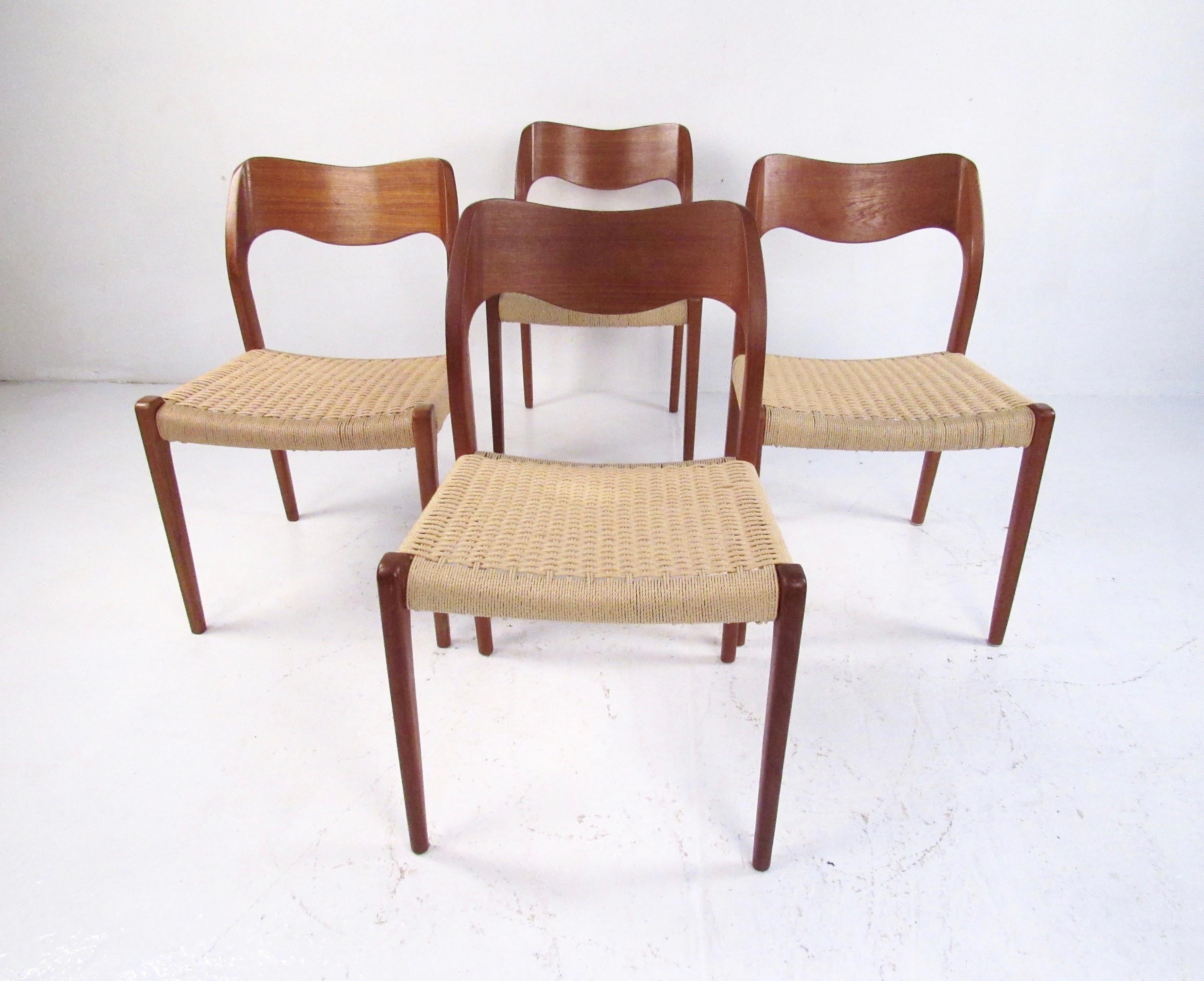 This stylish set of four Scandinavian Modern dining chairs feature sculpted teak frames, unique papercord seats, and iconic N.O. Møller design. Perfect set of Mid-Century Modern Danish chairs for kitchen or dining room seating. Please confirm item