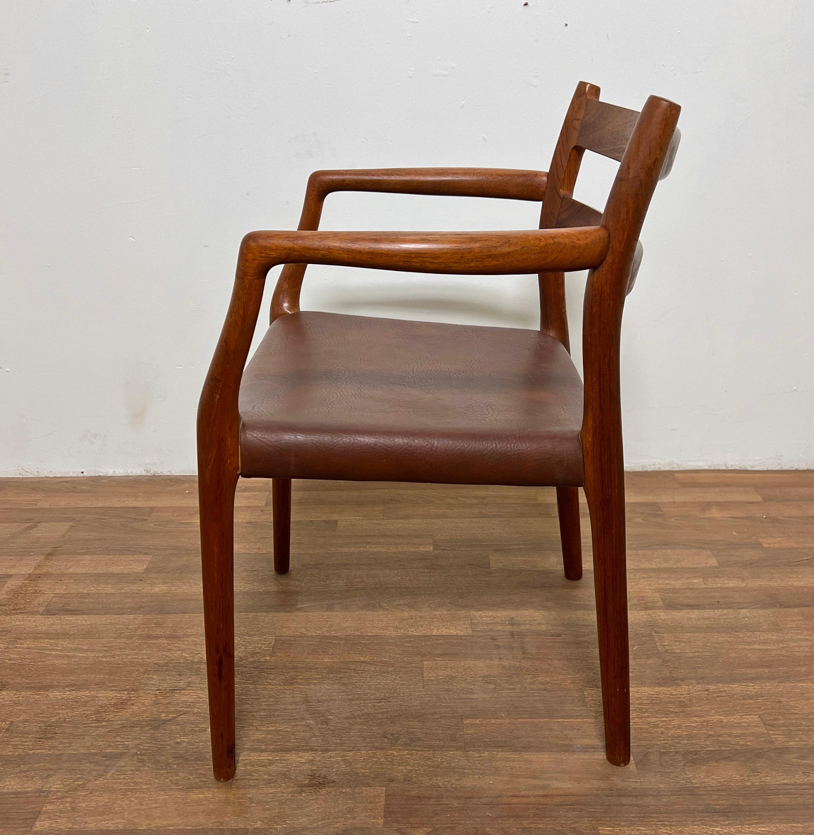 A model 67 arm chair in teak with leather seat, designed by Niels O. Moller for J.L. Moller, Denmark, circa 1970s.
