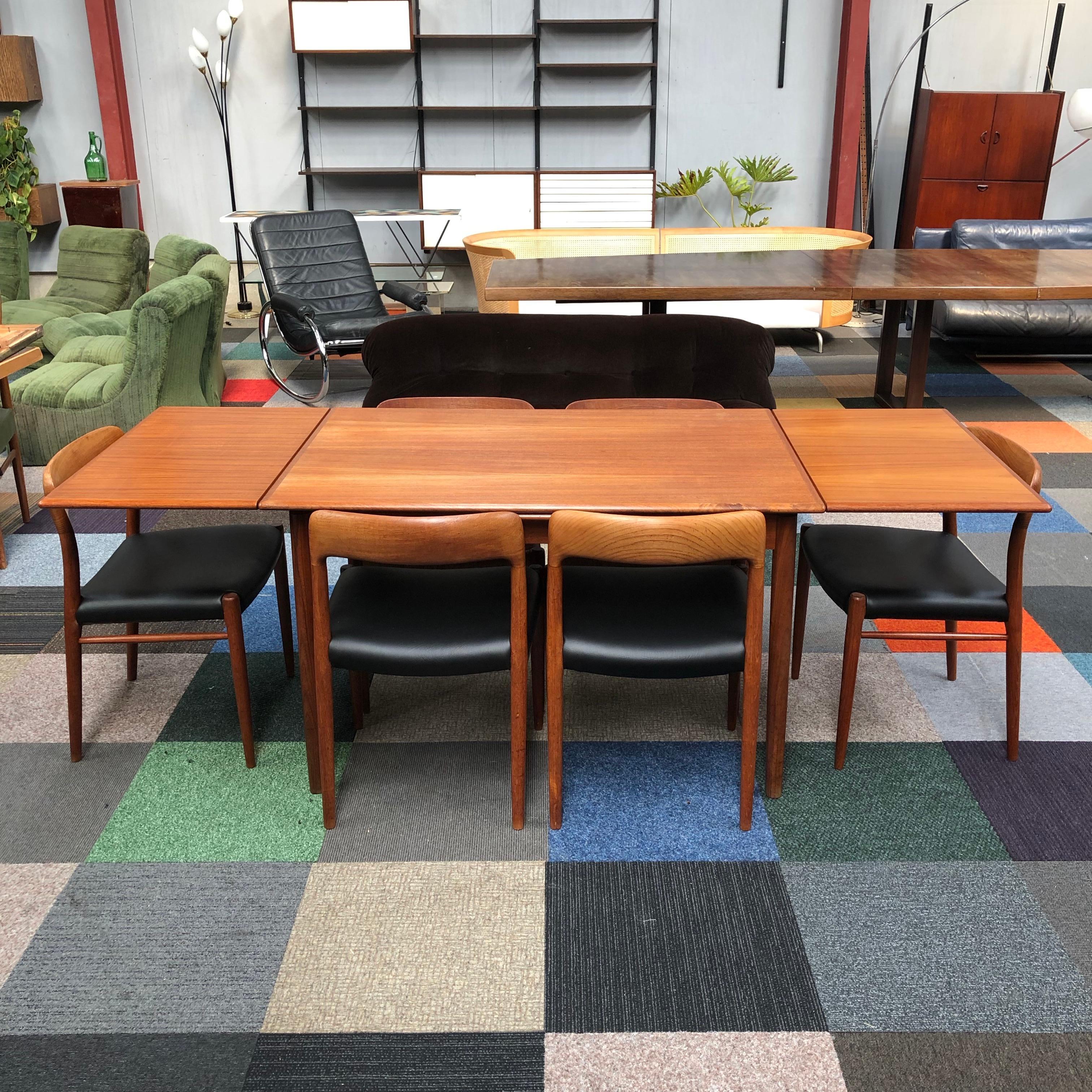 Extendable Niels Møller teak dining table with six Niels Møller model 75 Teak chairs.
The chairs have been re-upholstered with black faux leather (as originally also done).
The top of the table has been refinished.

Manufactured by the J.L.