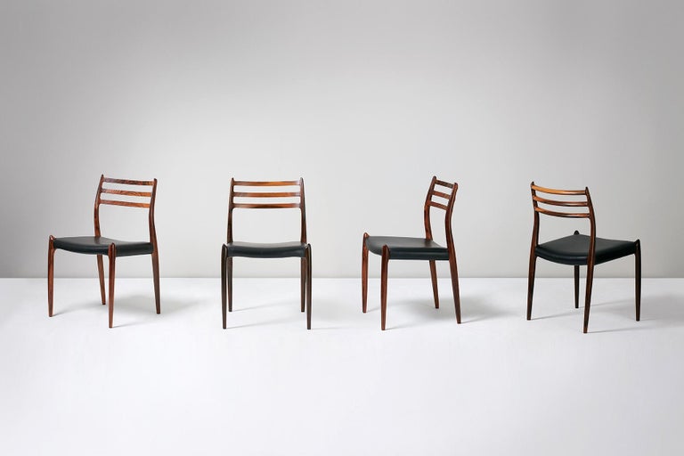 Niels O. Møller

Model 78 Dining Chairs, 1962.

Set of eight rosewood dining chairs designed by Niels O. Møller for J.L. Moller Mobelfabrik, Denmark, 1962. Seats reupholstered in premium black leather.

Larger sets and other upholstery options are