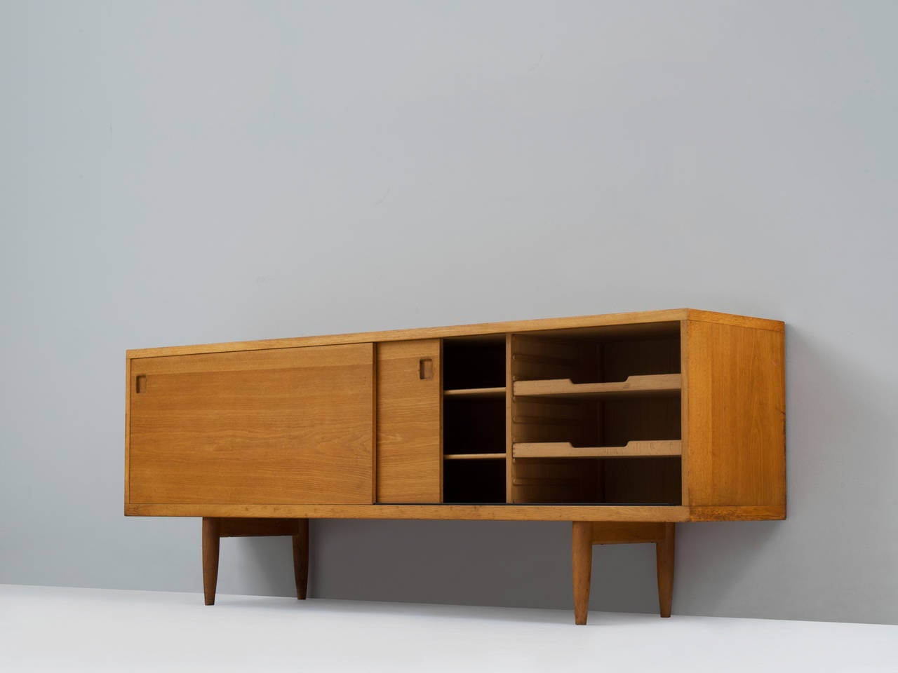Niels O. Møller, sideboard, oak, Denmark, 1960s.

This lovely medium-sized sideboard is a Classic example of the craftsmanship of Danish Mid-modern design. At the same time, it stands for the Scandinavian Postwar vision of practical yet well-made