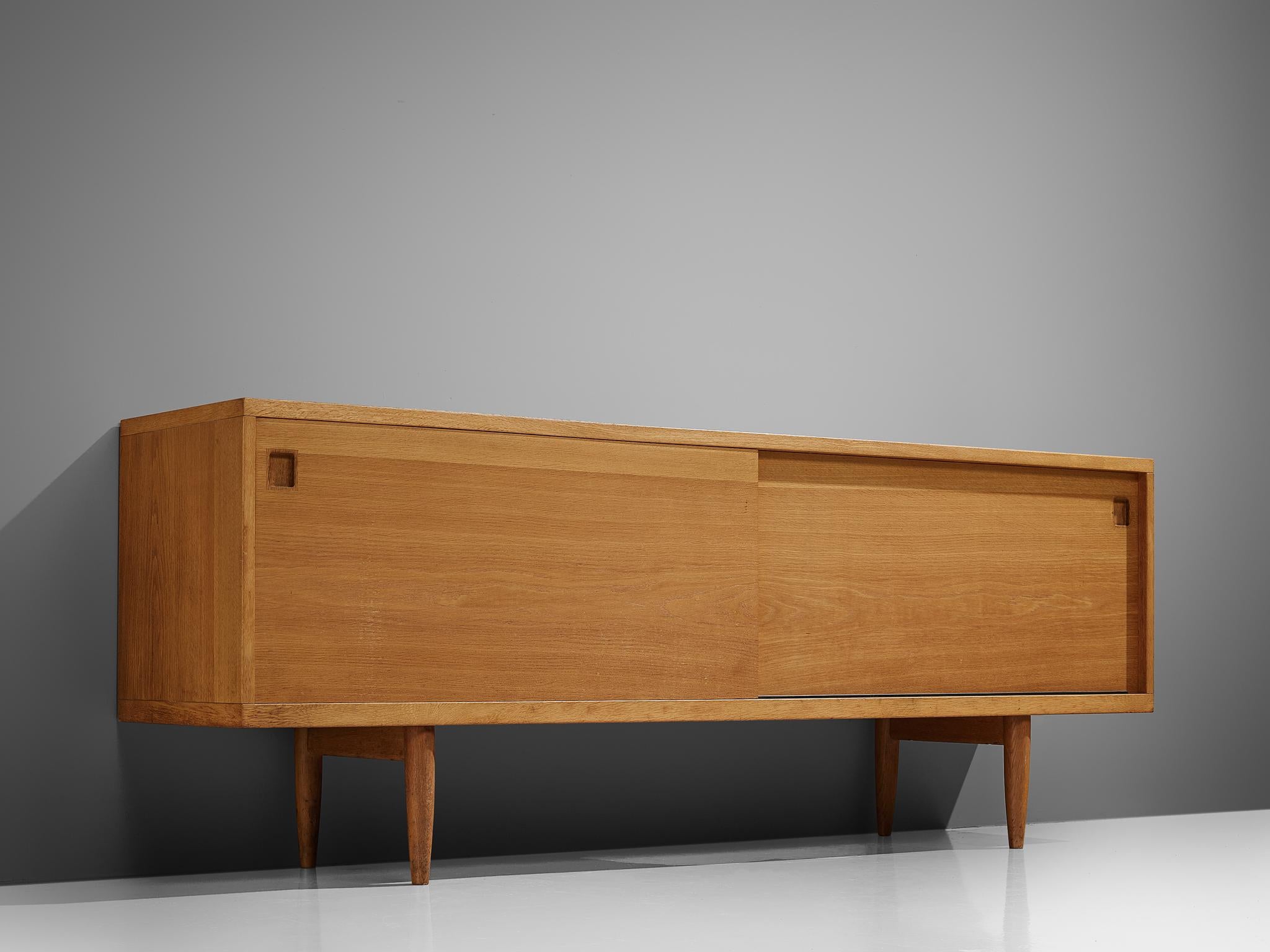 Niels O. Møller, sideboard, oak, Denmark, 1960s.

This lovely medium-sized sideboard is a Classic example of the craftsmanship of Danish mid-modern design. At the same time, it stands for the Scandinavian Postwar vision of practical yet well-made
