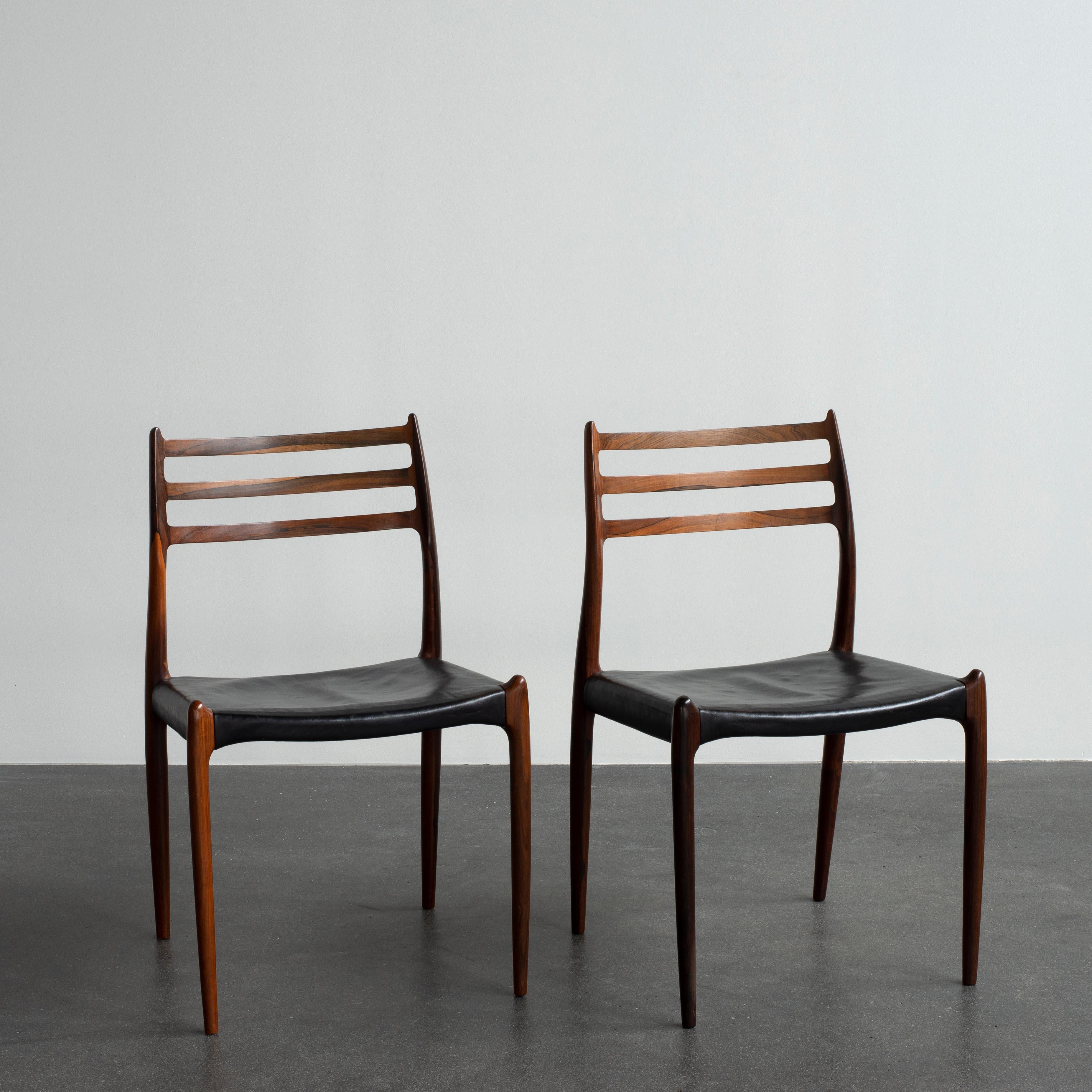 Niels O. Møller pair of rosewood chairs, seats leather. Manufactured by J. L. Møller, Denmark.