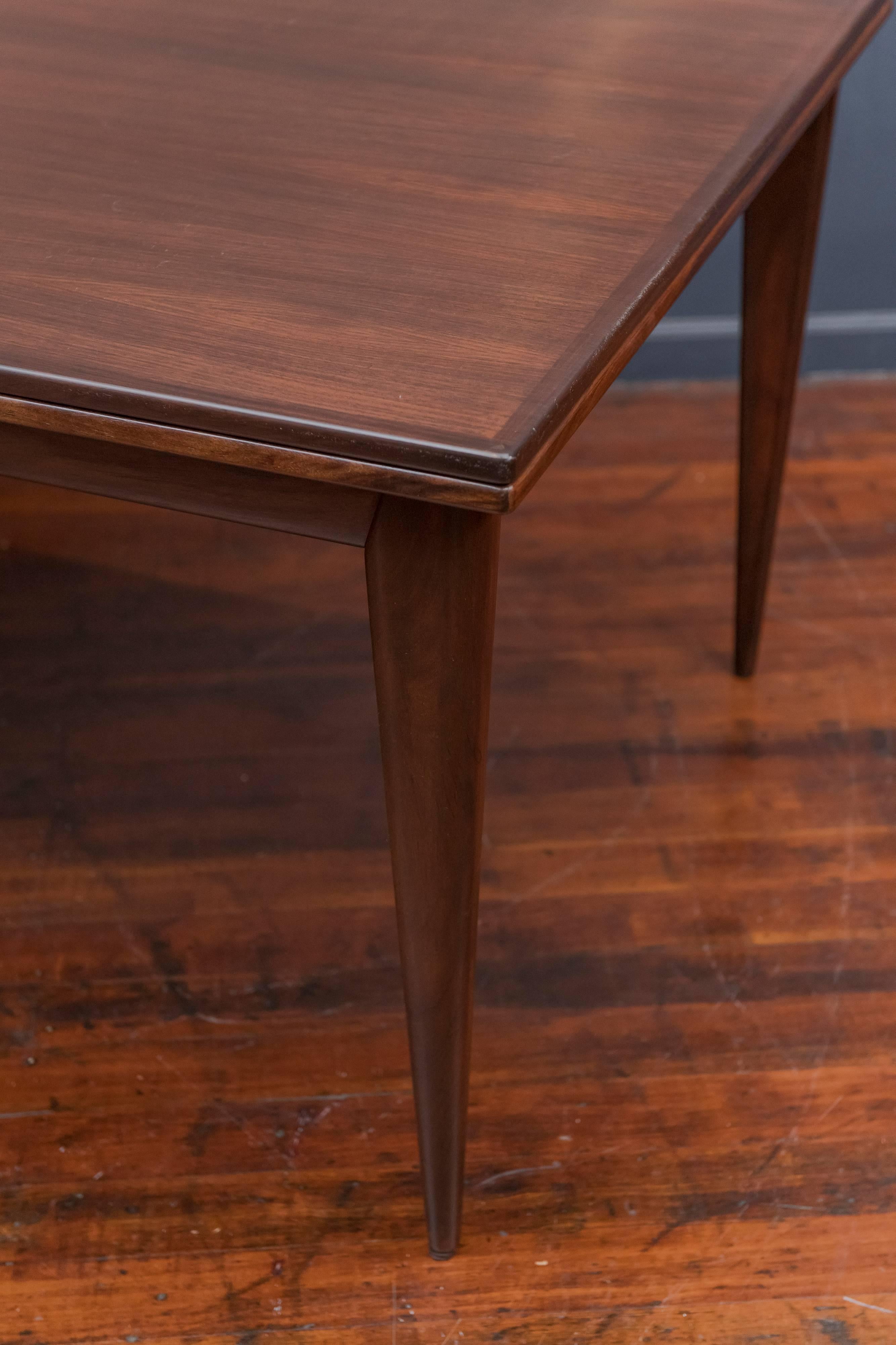 Beautiful model #12 dining table with tapered legs and self-storing leaves by Niels Otto Møller for J.L. Møller. Signed with manufacturer's sticker and Danish control sticker. Table measures 59