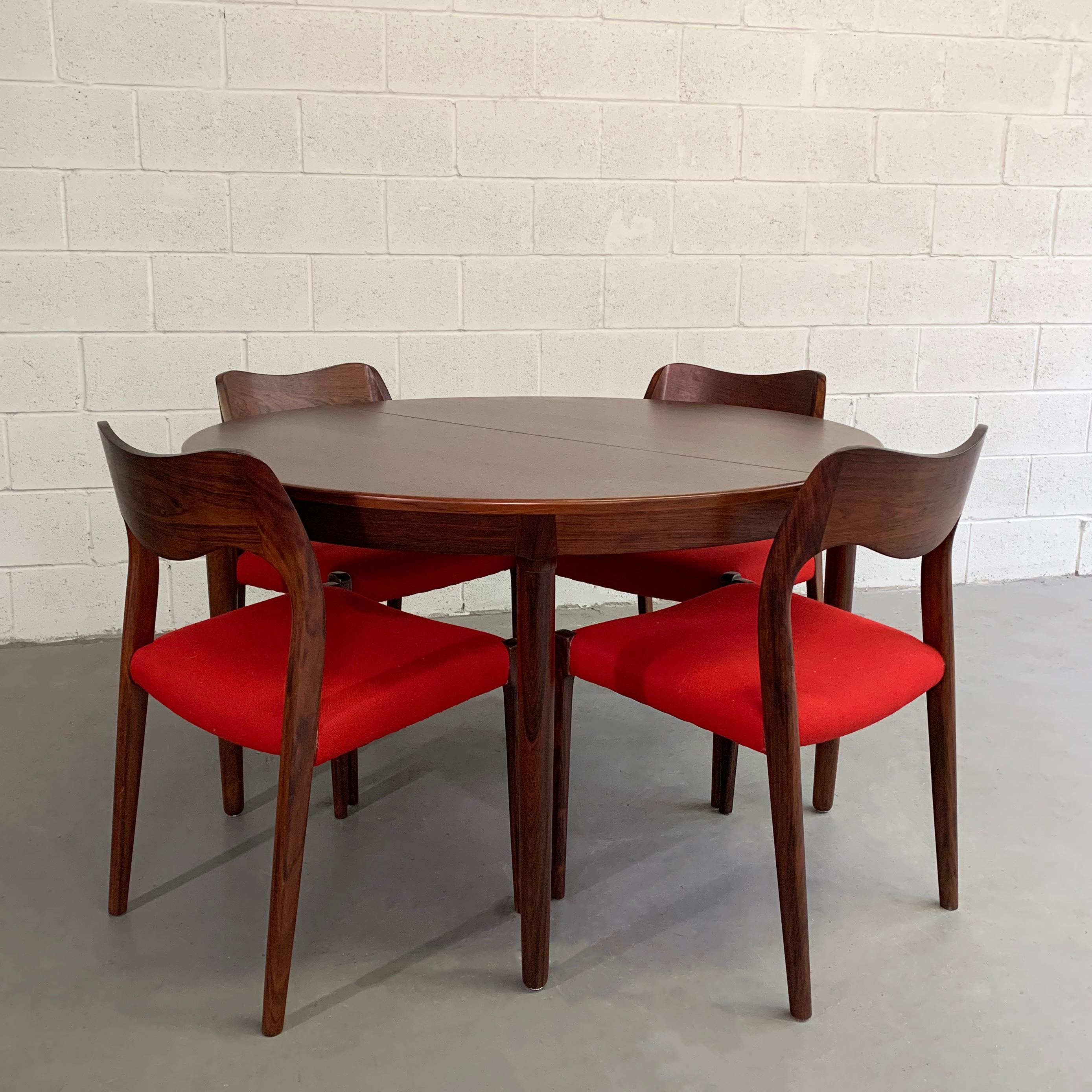 Danish modern, rosewood dining set by Niels O Moller features 4 model #71 chairs and two separate 19.5 inch leaves that extend the table to 66 inches with one leaf up to 86 inches with both leaves. The chairs measure 19.5 W x 18 D x 30.25 HT, seat