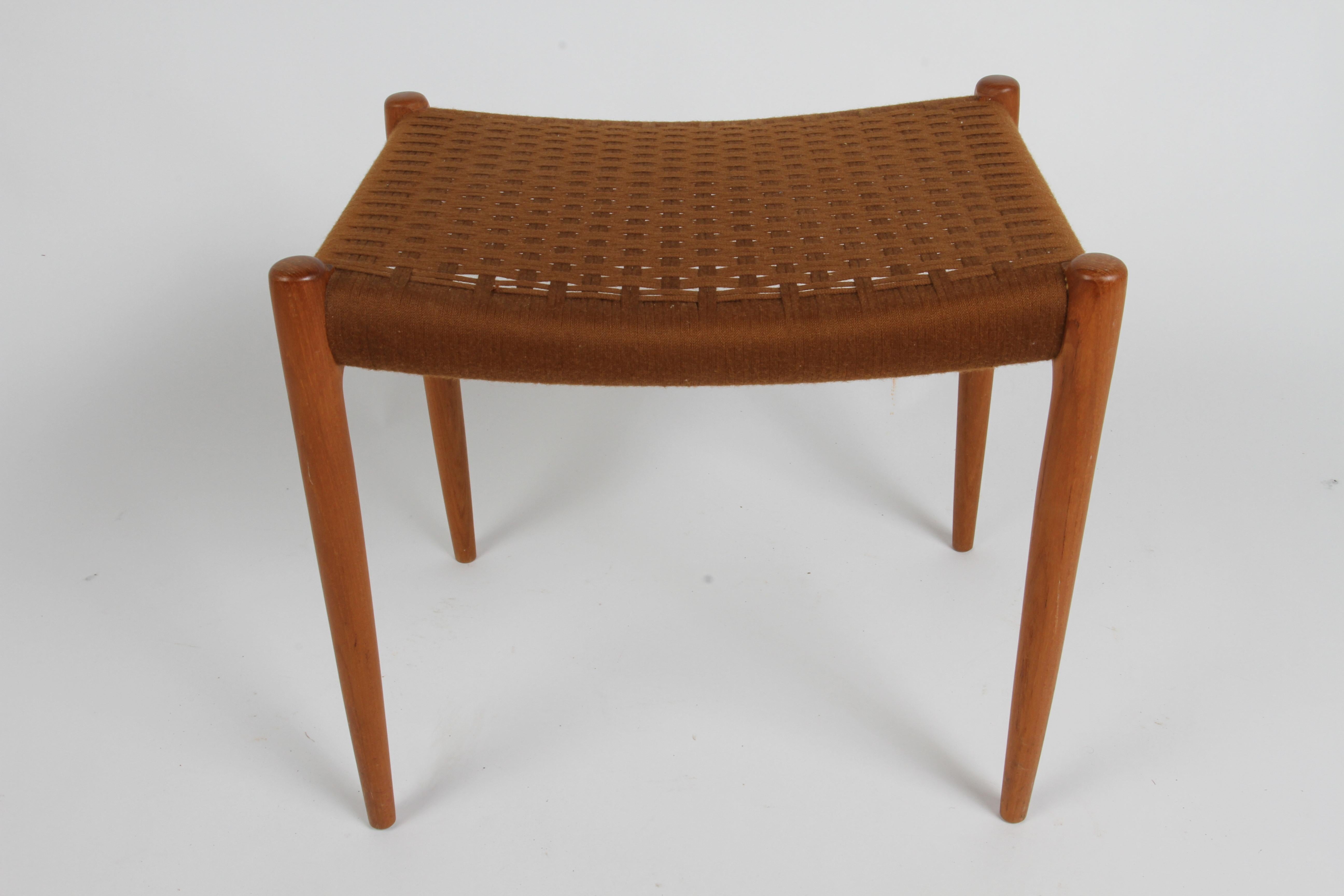 Niels Otto Møller for J.L. Møllers Møbelfabrik in Denmark, model 80A ottoman or bench first designed in 1963
Stamped (J.L. Møller Models made in Denmark) underneath ottoman. Features beautifully sculpted teak frame with woven textile seat. Original