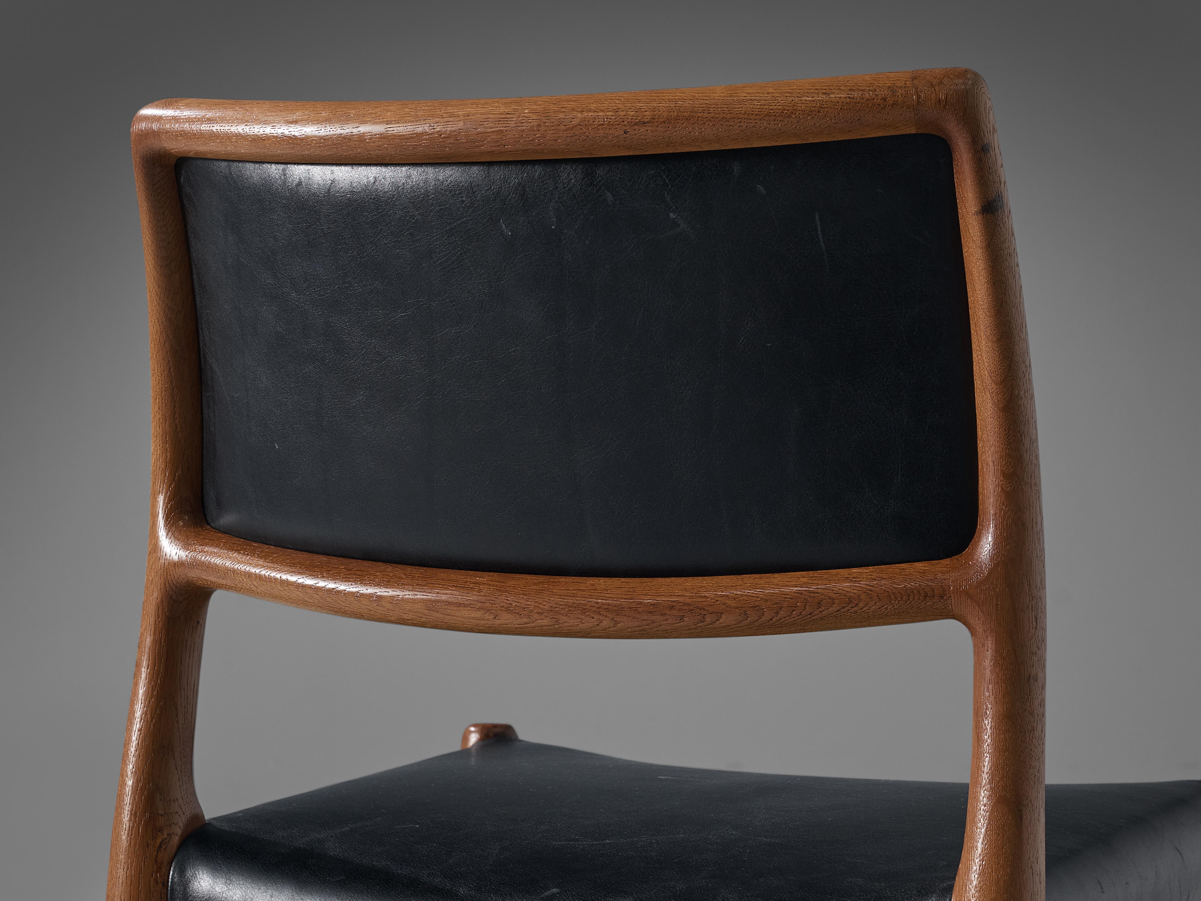 Niels Otto Møller for J.L. Møllers, dining chair, in oak and leather, Denmark, 1960s.

Niels Otto Møller dining chair with black leather upholstery. This design is very refined. The elegant designed open shape of the frame in combination with