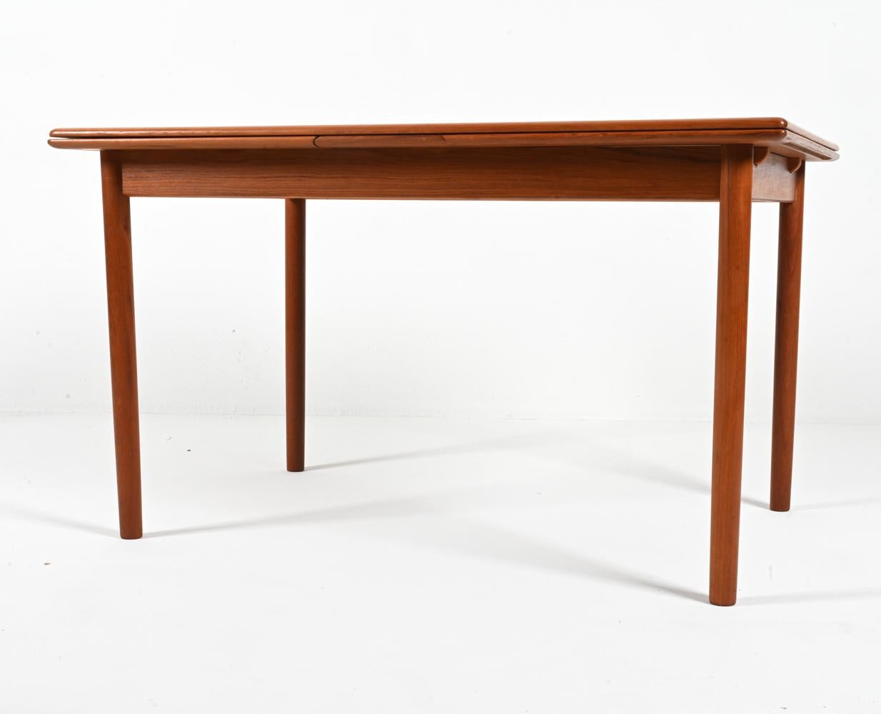 Presenting a classic Danish Mid-Century dining table in pristine vintage condition, designed by Niels Otto Møller for J.L. Møllers Møbelfabrik and crafted from luminous teak wood. This example features a rectangular silhouette with simple round