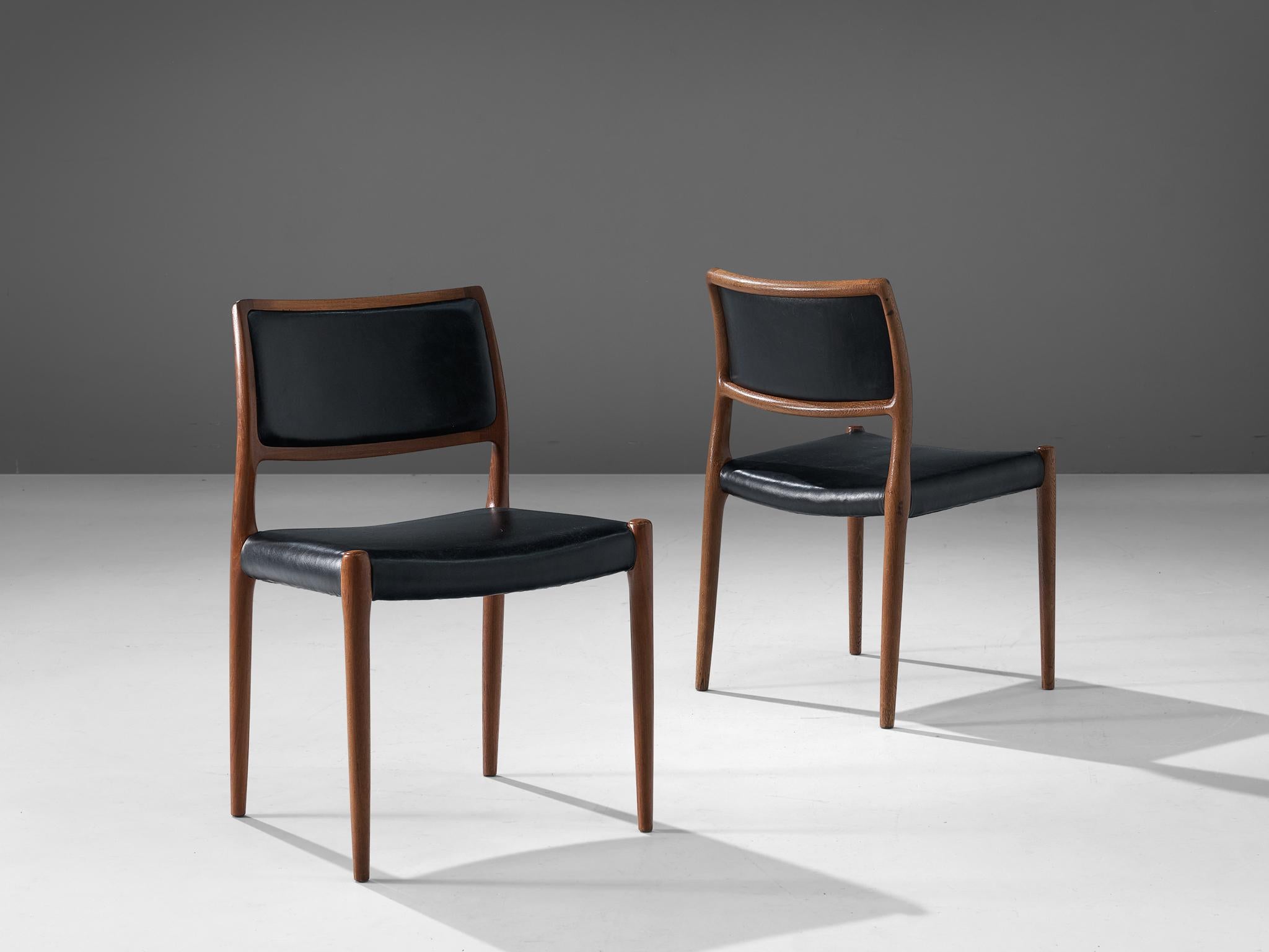 Niels Otto Møller for J. L. Møllers, pair of dining chairs, in teak and leather, Denmark, 1960s.

Niels Otto Møller dining chairs with black leather upholstery. This design is very refined and stylish. The elegant designed open shape of the frame in